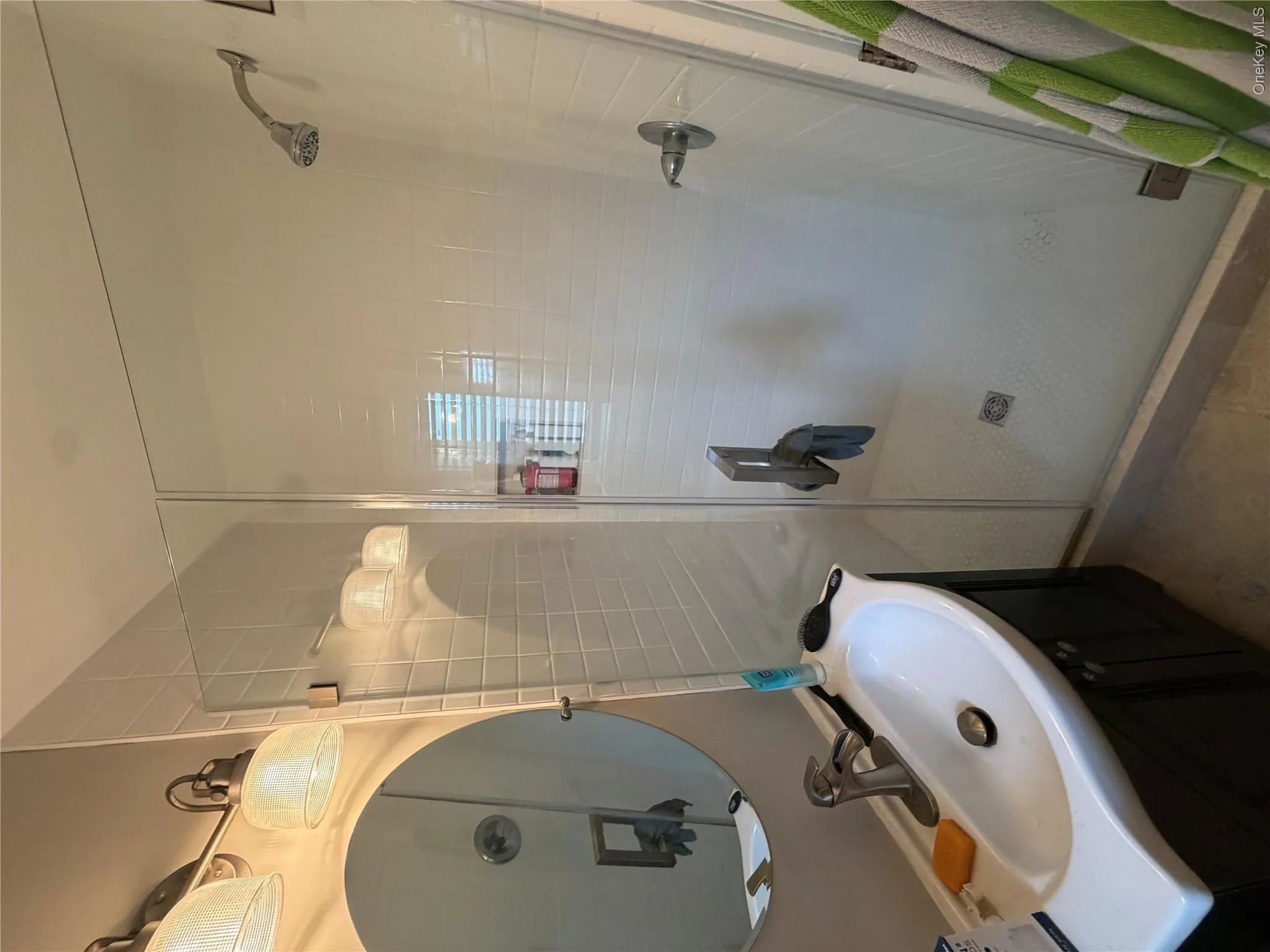 Bathroom with glass wall in shower, and elegant fixtures Bathroom with glass wall in shower, and elegant fixtures