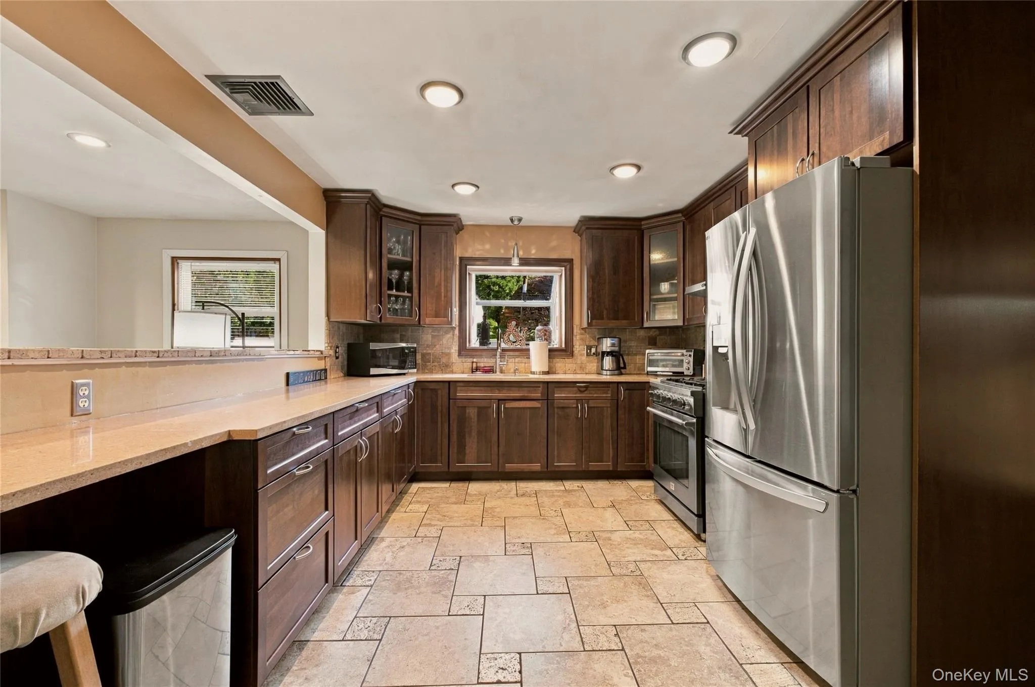 Gourmet kitchen with wood cabinets, stainless steel appliances, and recess lighting Gourmet kitchen with wood cabinets, stainless steel appliances, and recess lighting