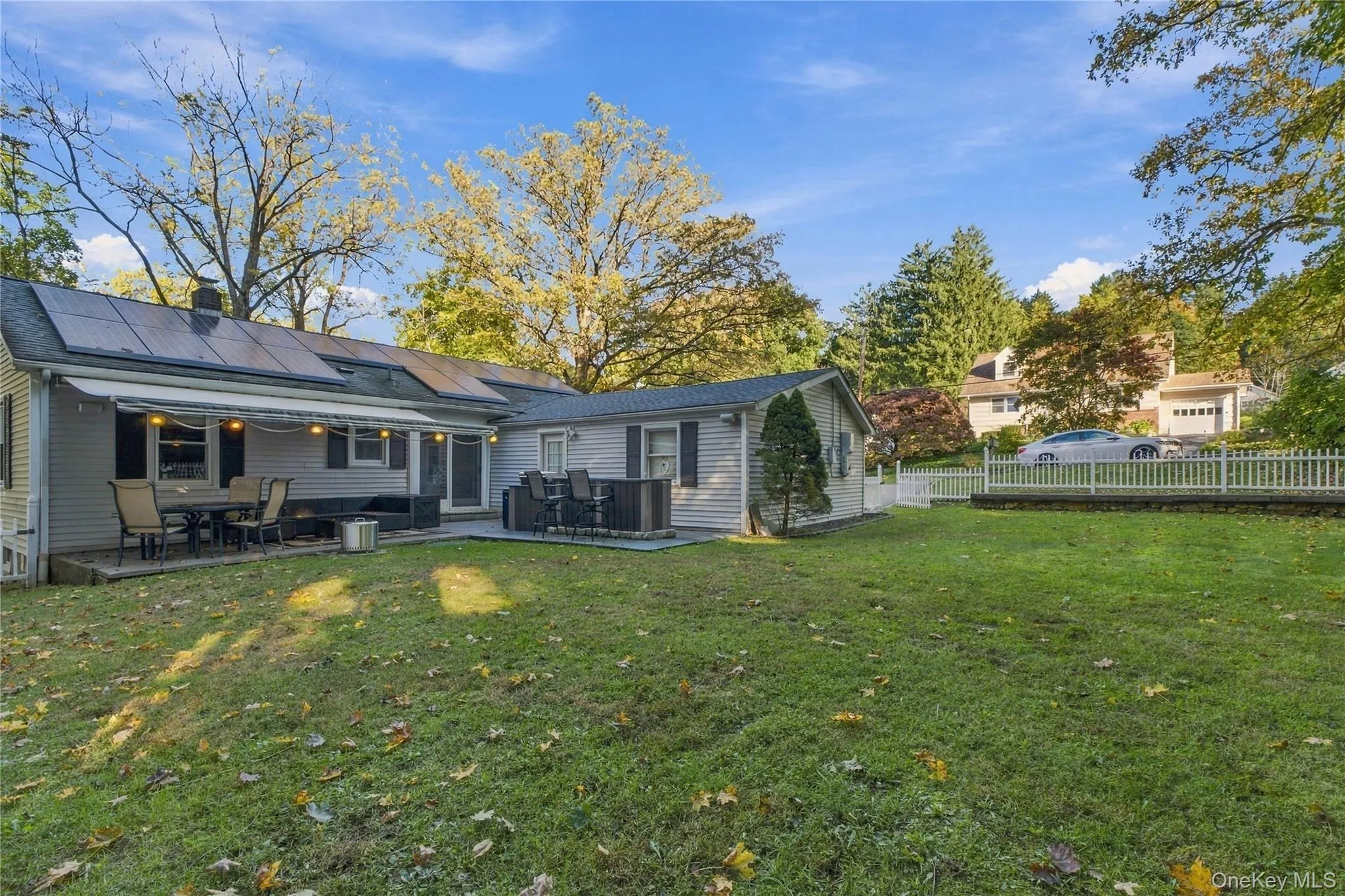 Back yard with stone patio and retractable awning Back yard with stone patio and retractable awning