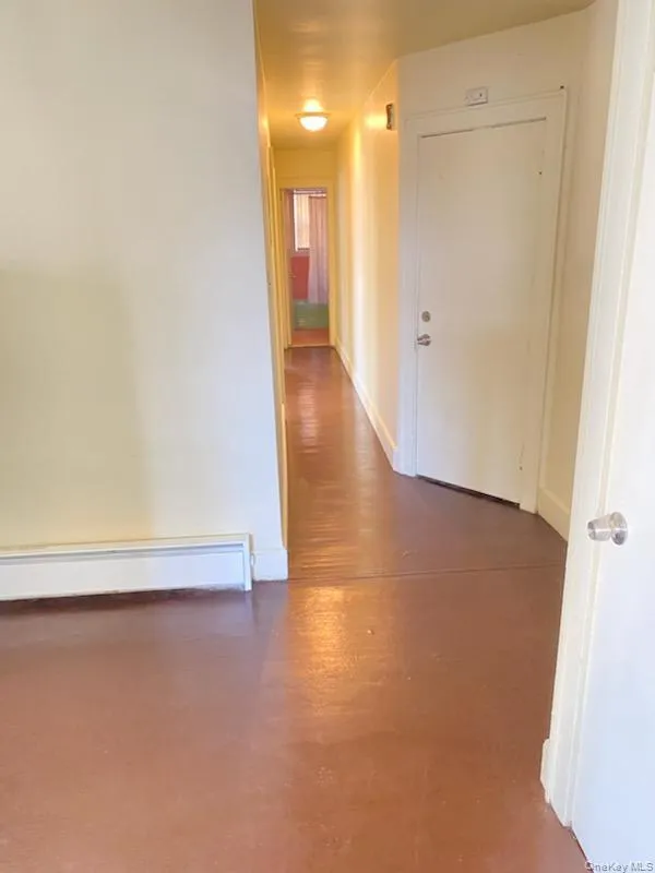 Recessed ceiling light fixtures illuminate the hallway with a durable flooring surface Recessed ceiling light fixtures illuminate the hallway with a durable flooring surface