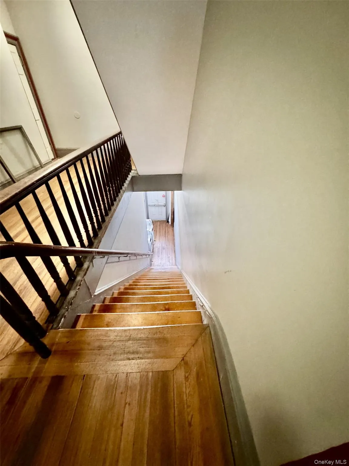 Stairway featuring baseboards and wood finished floors Stairway featuring baseboards and wood finished floors