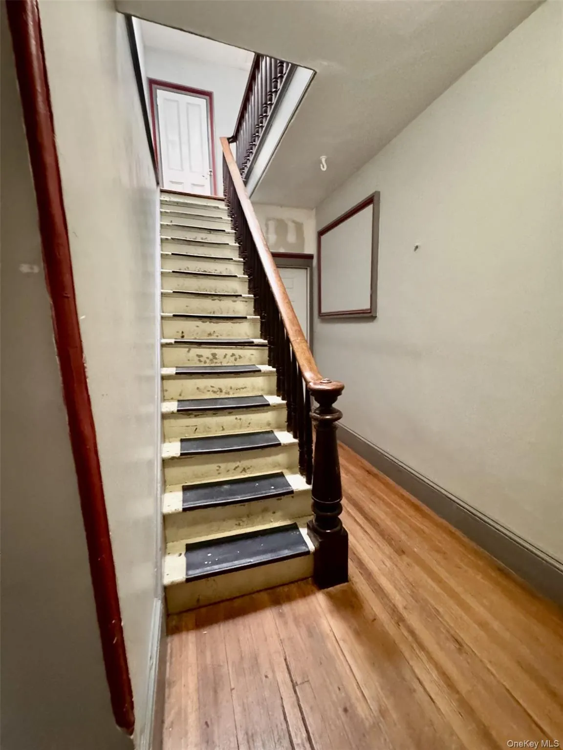 Stairway with wood-type flooring and baseboards Stairway with wood-type flooring and baseboards