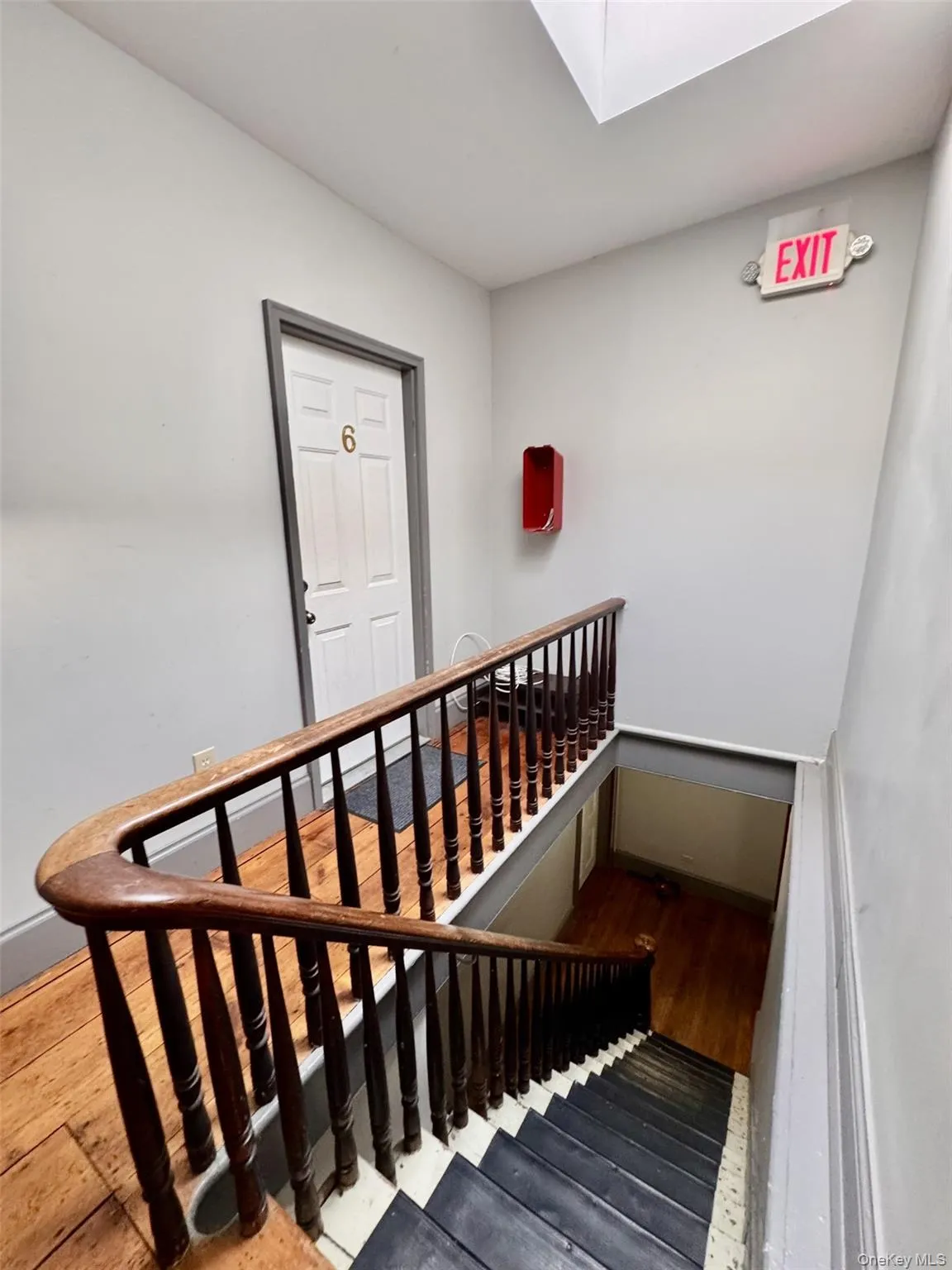 Stairs with wood finished floors and a skylight Stairs with wood finished floors and a skylight
