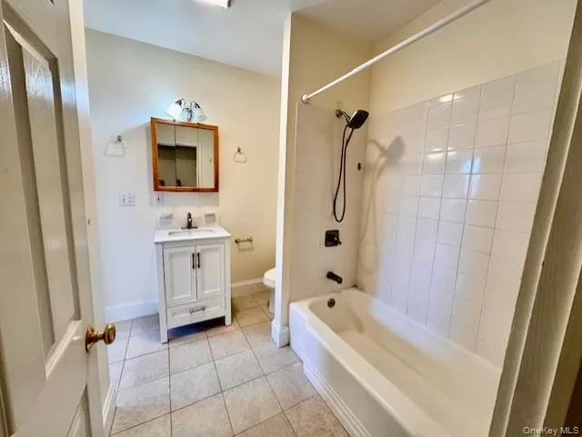 Full bath with tile patterned flooring, vanity, and shower / bathtub combination Full bath with tile patterned flooring, vanity, and shower / bathtub combination