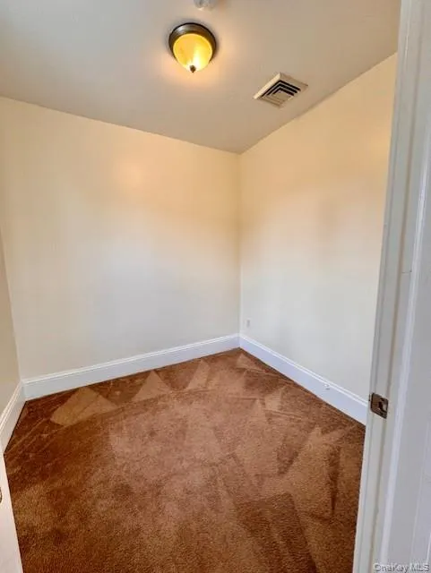 Carpeted empty room featuring baseboards Carpeted empty room featuring baseboards