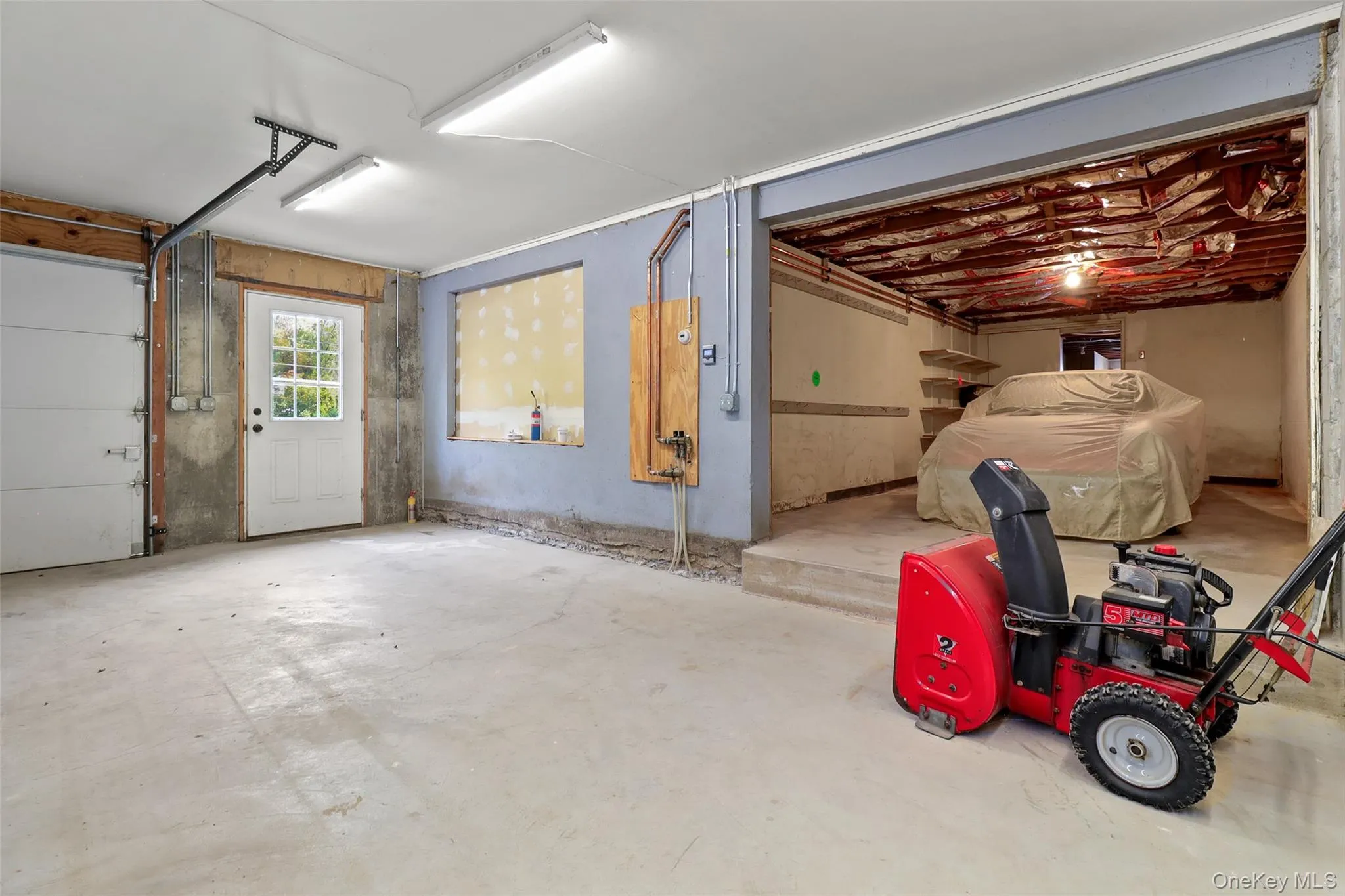 This two-car garage has a pre-existing 3rd car bay This two-car garage has a pre-existing 3rd car bay