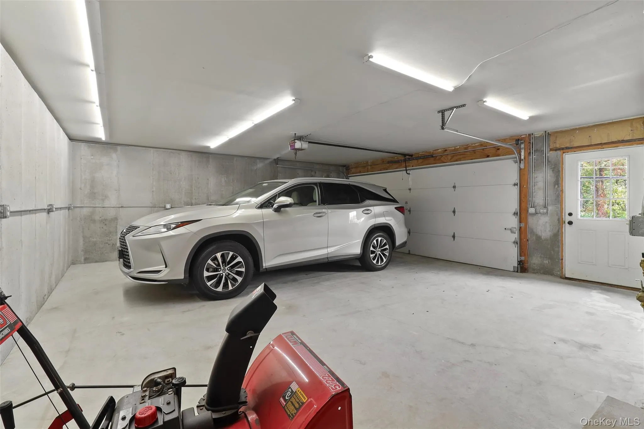This well-lit, poured concrete two car garage with no pillars was added to the house in 2000. This well-lit, poured concrete two car garage with no pillars was added to the house in 2000.