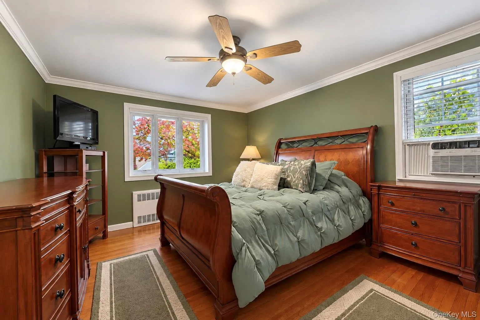 Hardwood flooring, multi-pane windows, crown molding, and a central ceiling fan with integrated lighting Hardwood flooring, multi-pane windows, crown molding, and a central ceiling fan with integrated lighting