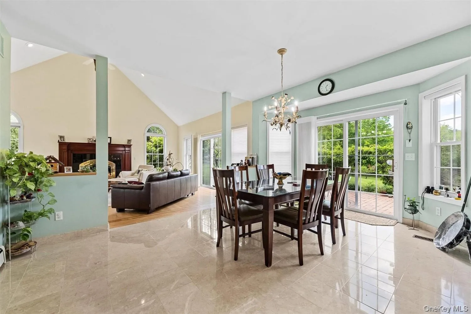 Dining area with plenty of natural light, suspended lighting, a fireplace, and lofted ceiling Dining area with plenty of natural light, suspended lighting, a fireplace, and lofted ceiling
