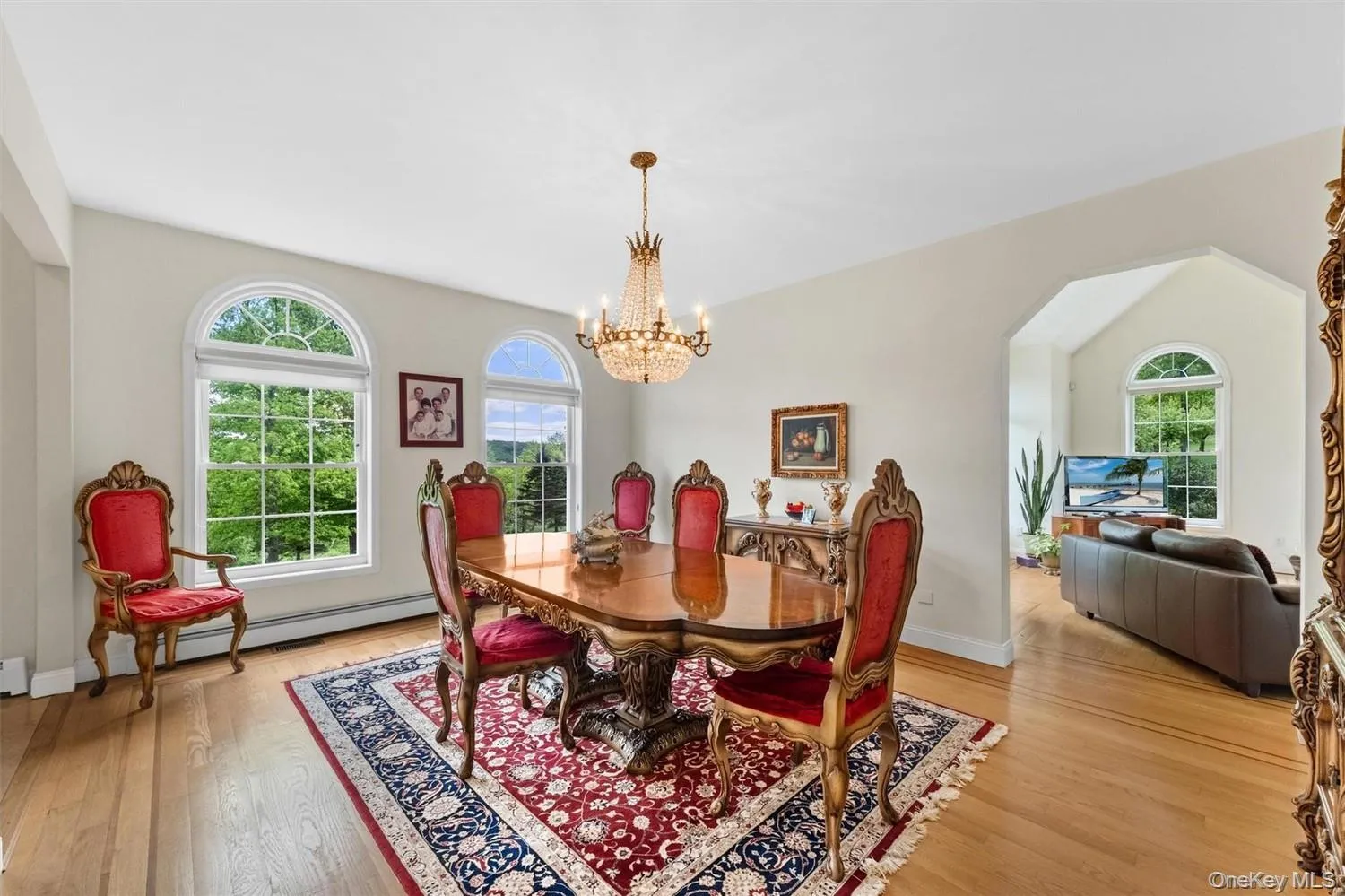 Dining room with hanging lights, light wood-type flooring, arched walkways, and vaulted ceiling Dining room with hanging lights, light wood-type flooring, arched walkways, and vaulted ceiling