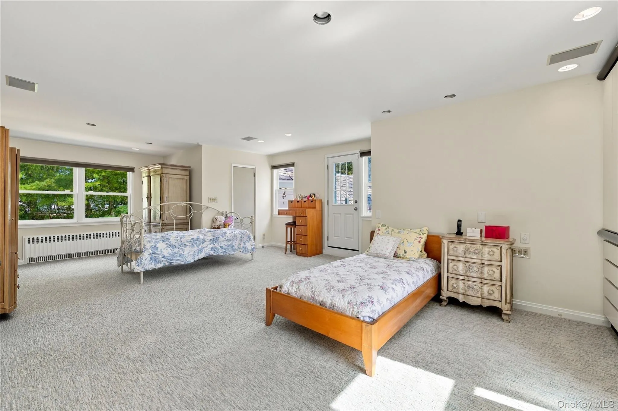 Spacious interior featuring wall-to-wall carpeting, recessed lighting, and a multi-pane glass door leading to the exterior Spacious interior featuring wall-to-wall carpeting, recessed lighting, and a multi-pane glass door leading to the exterior