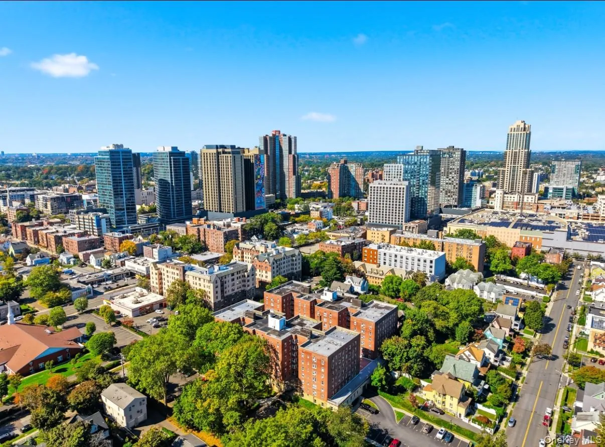 Aerial view of 70 locust Avenue and the surrounding New Rochelle neighborhood, showcasing tree-lined streets, residential buildings, and the downtown skyline. Aerial view of 70 locust Avenue and the surrounding New Rochelle neighborhood, showcasing tree-lined streets, residential buildings, and the downtown skyline.