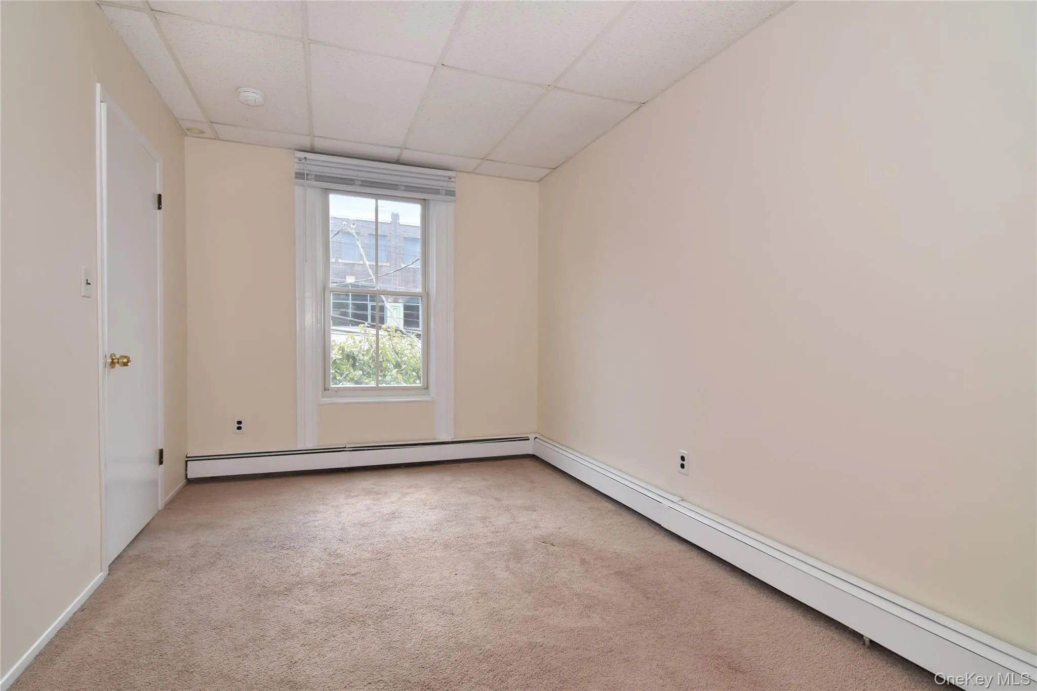 Bedroom featuring a front facing window that overlooks Main Street. Bedroom featuring a front facing window that overlooks Main Street.