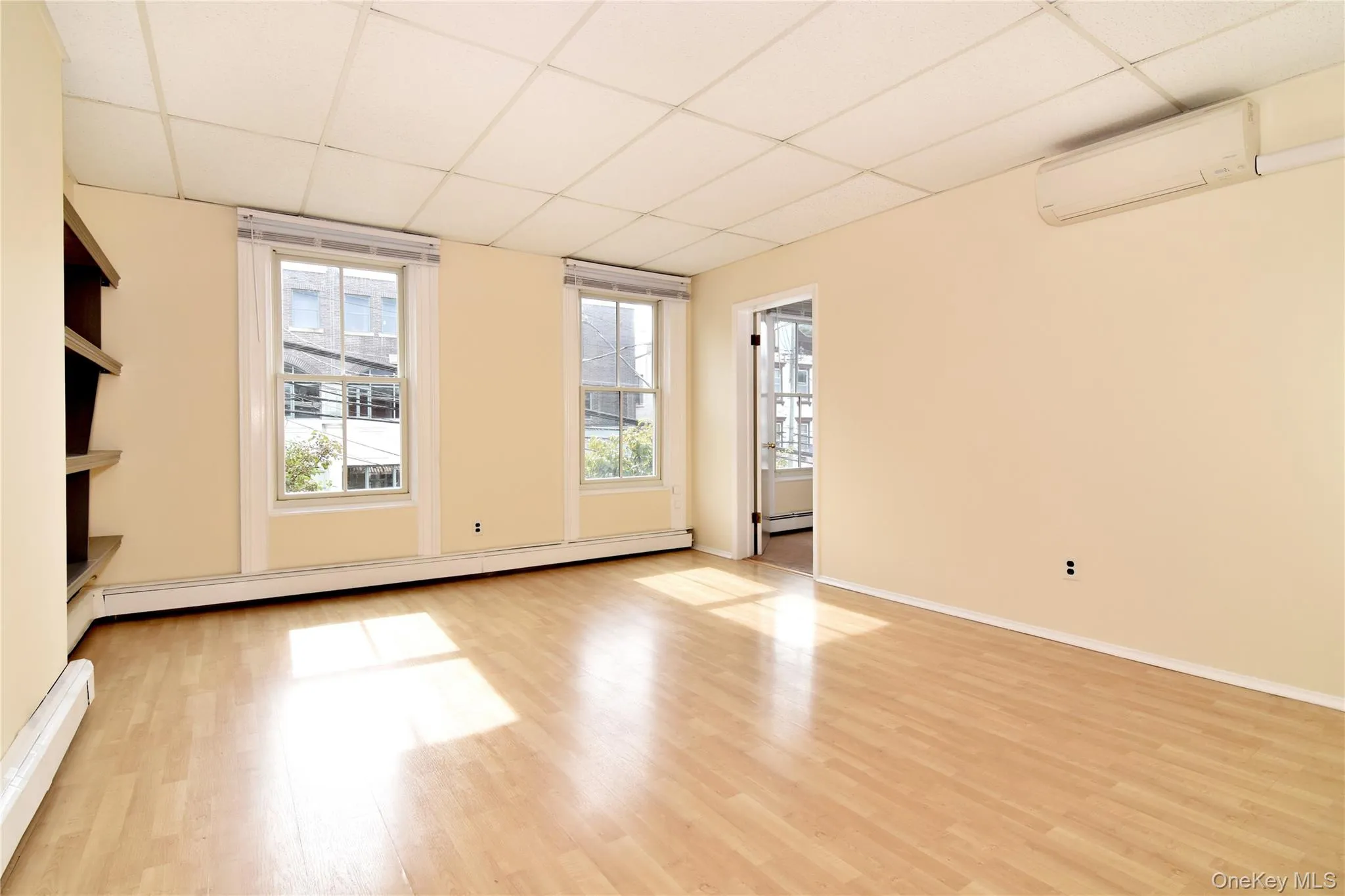 Living room and dining area. Featuring two front facing windows and a mini-split unit. Living room and dining area. Featuring two front facing windows and a mini-split unit.