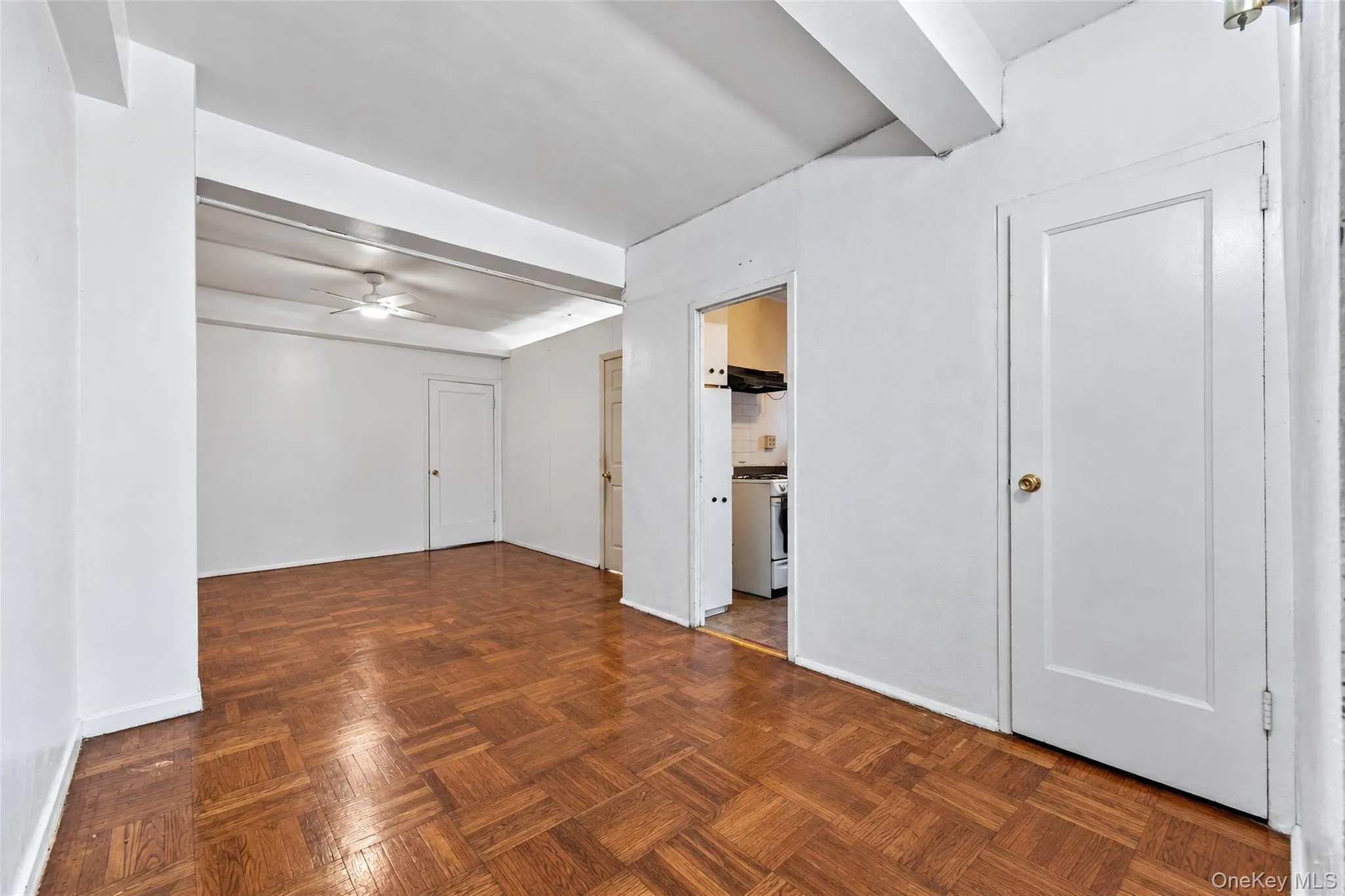 Parquet wood-finish flooring, recessed beam ceiling detailing, and solid core interior doors Parquet wood-finish flooring, recessed beam ceiling detailing, and solid core interior doors
