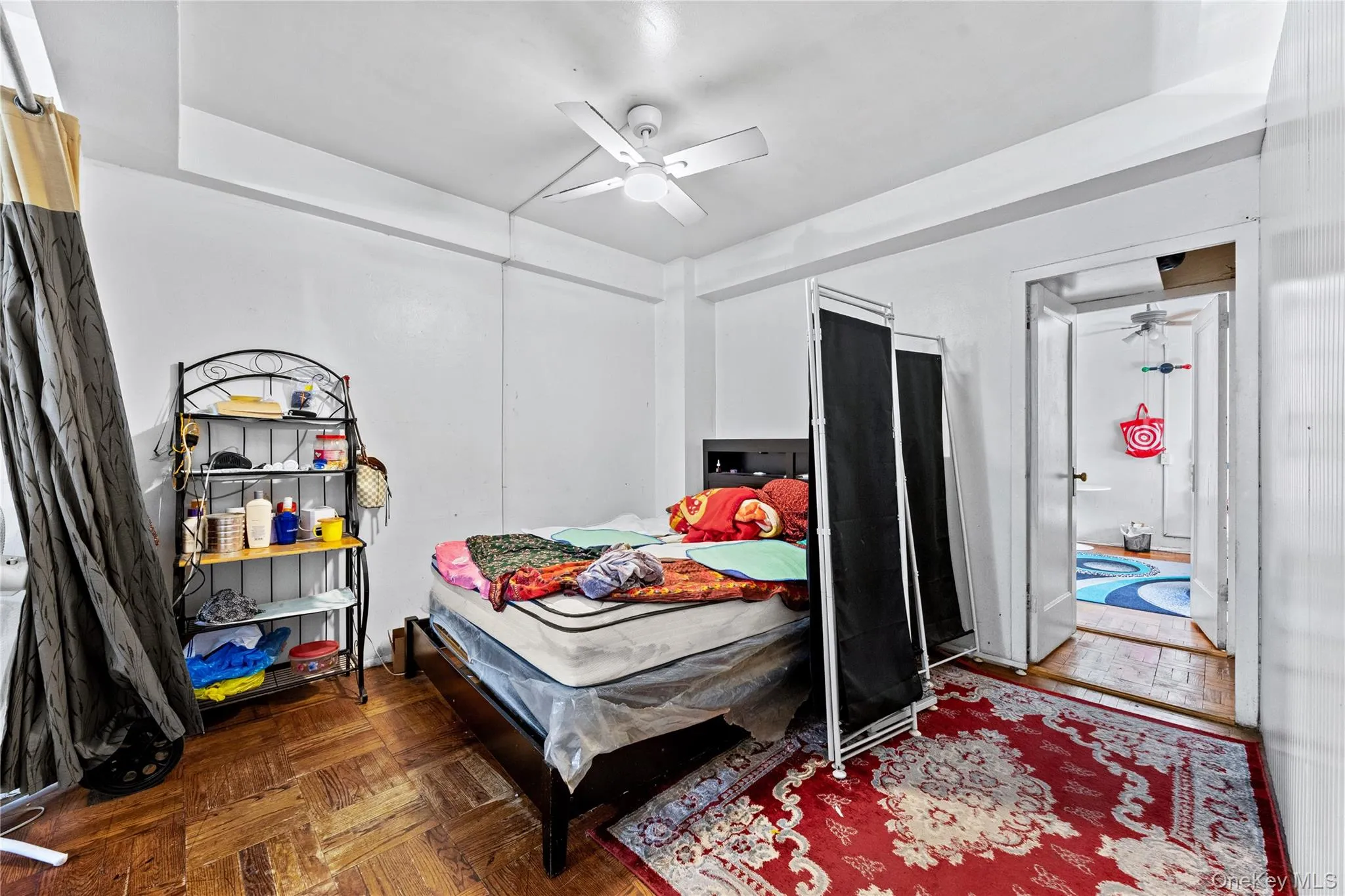Parquet wood-finish flooring, recessed tray ceiling, and ceiling-mounted fan Parquet wood-finish flooring, recessed tray ceiling, and ceiling-mounted fan
