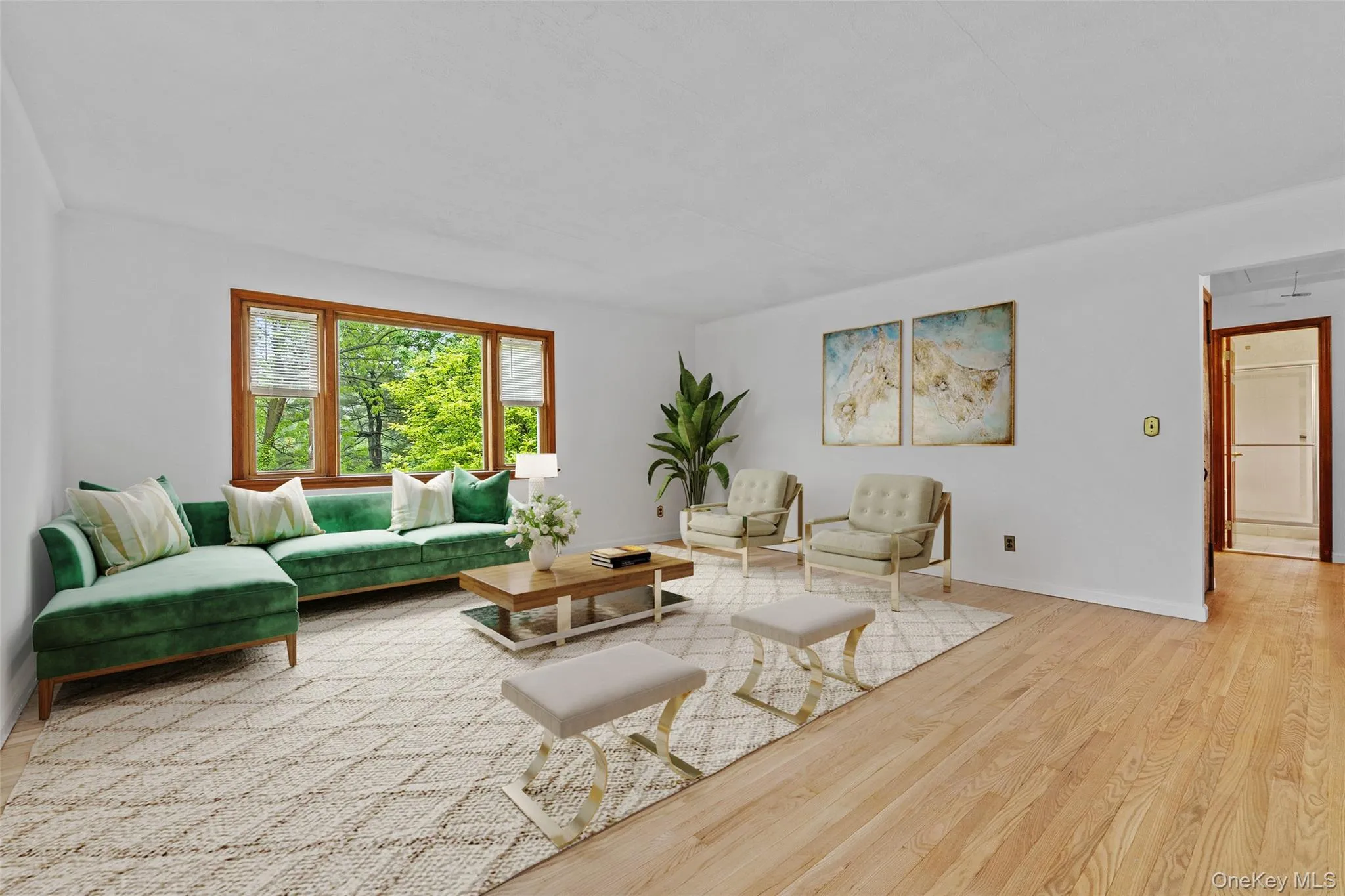 Living area featuring wood finished floors, attic access, and baseboards Living area featuring wood finished floors, attic access, and baseboards