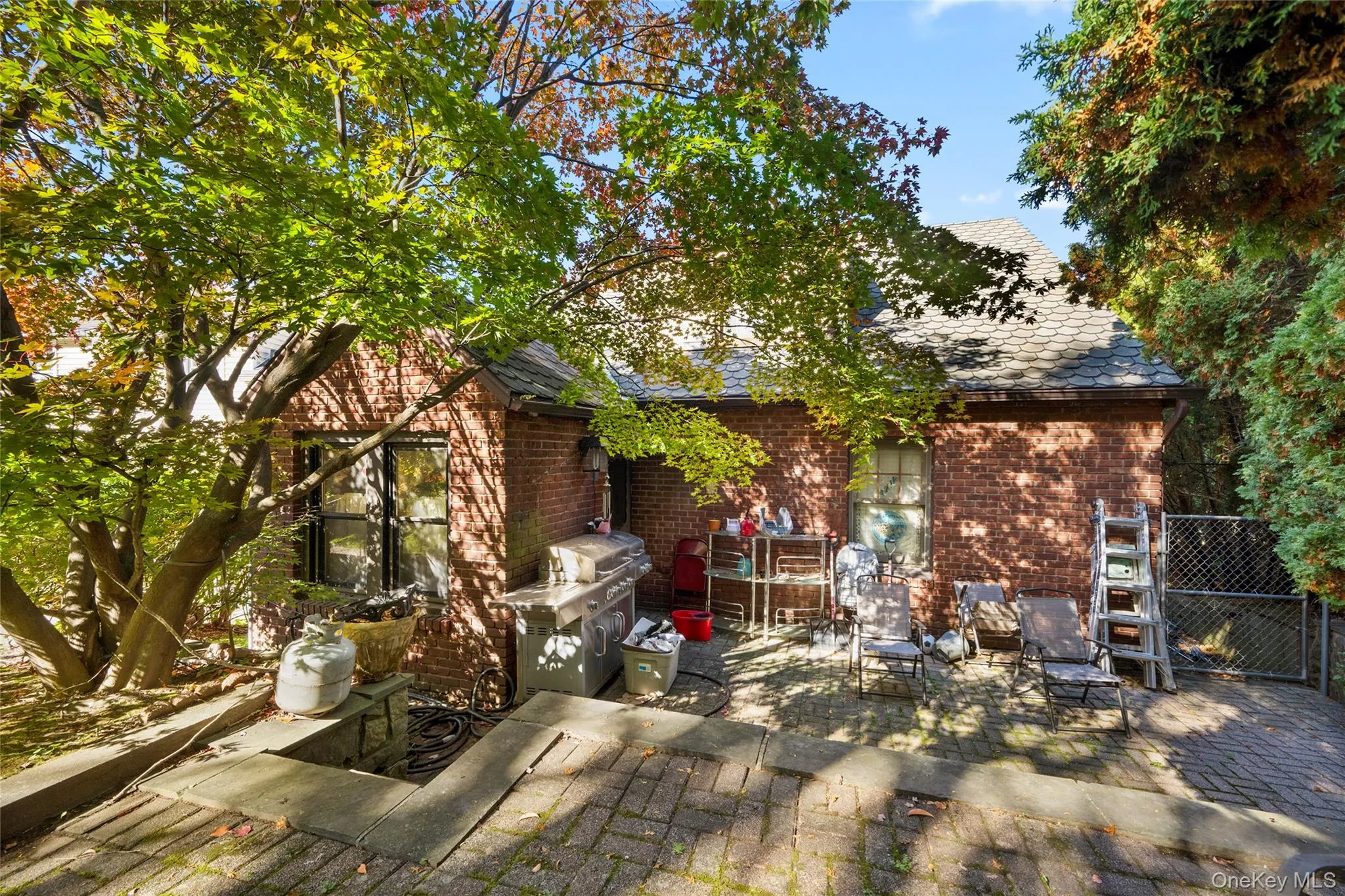 Brick exterior, paved patio, and mature trees Brick exterior, paved patio, and mature trees