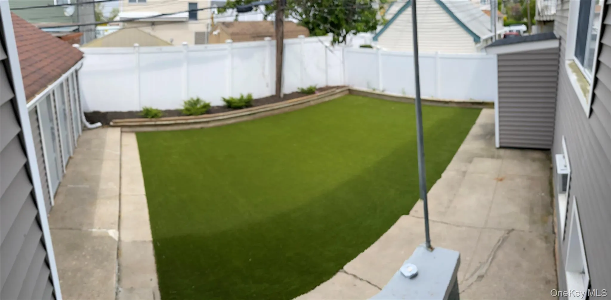 Fenced backyard featuring a bocce ball area Fenced backyard featuring a bocce ball area