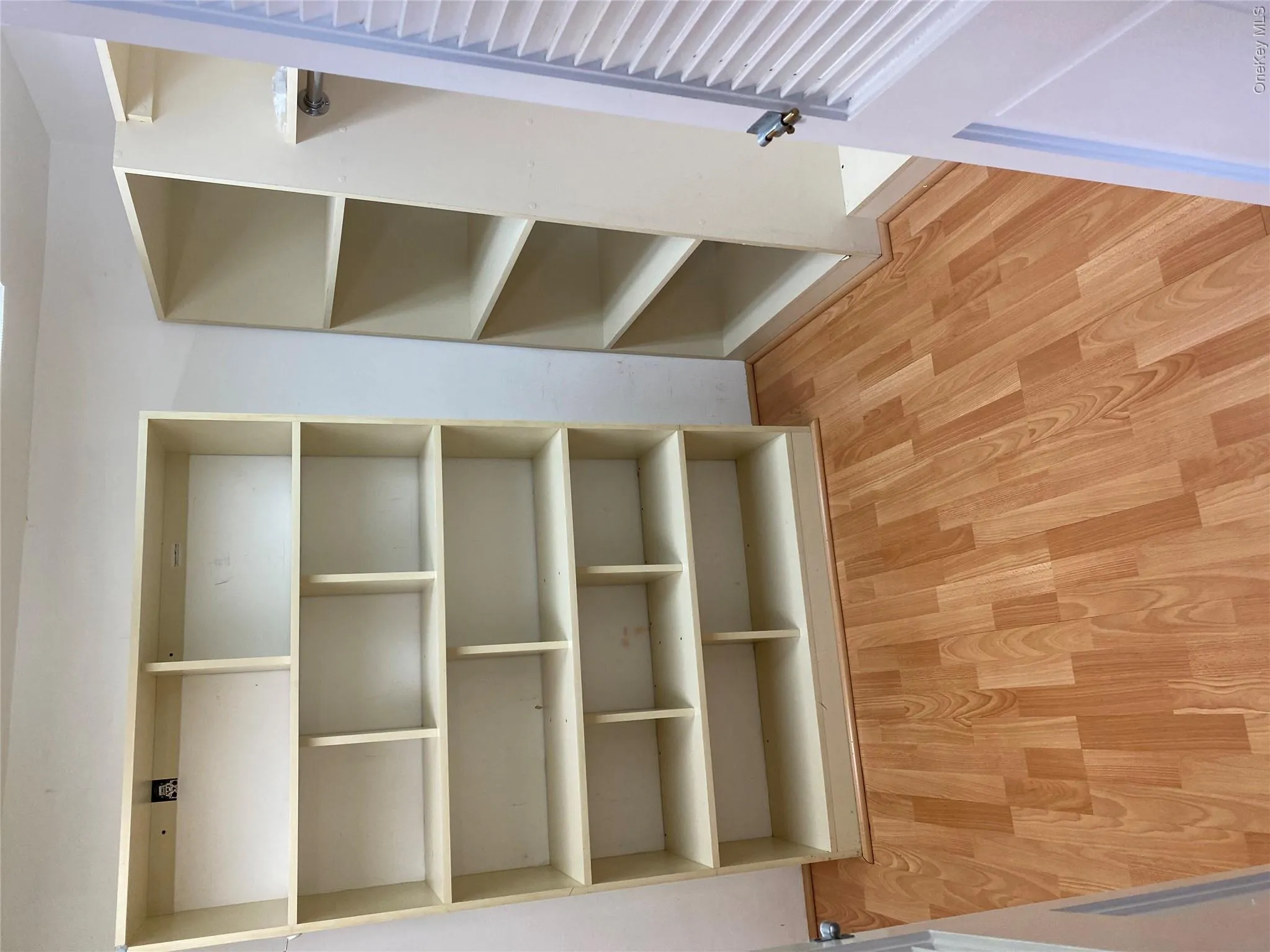 Spacious closet with wood finished floors Spacious closet with wood finished floors