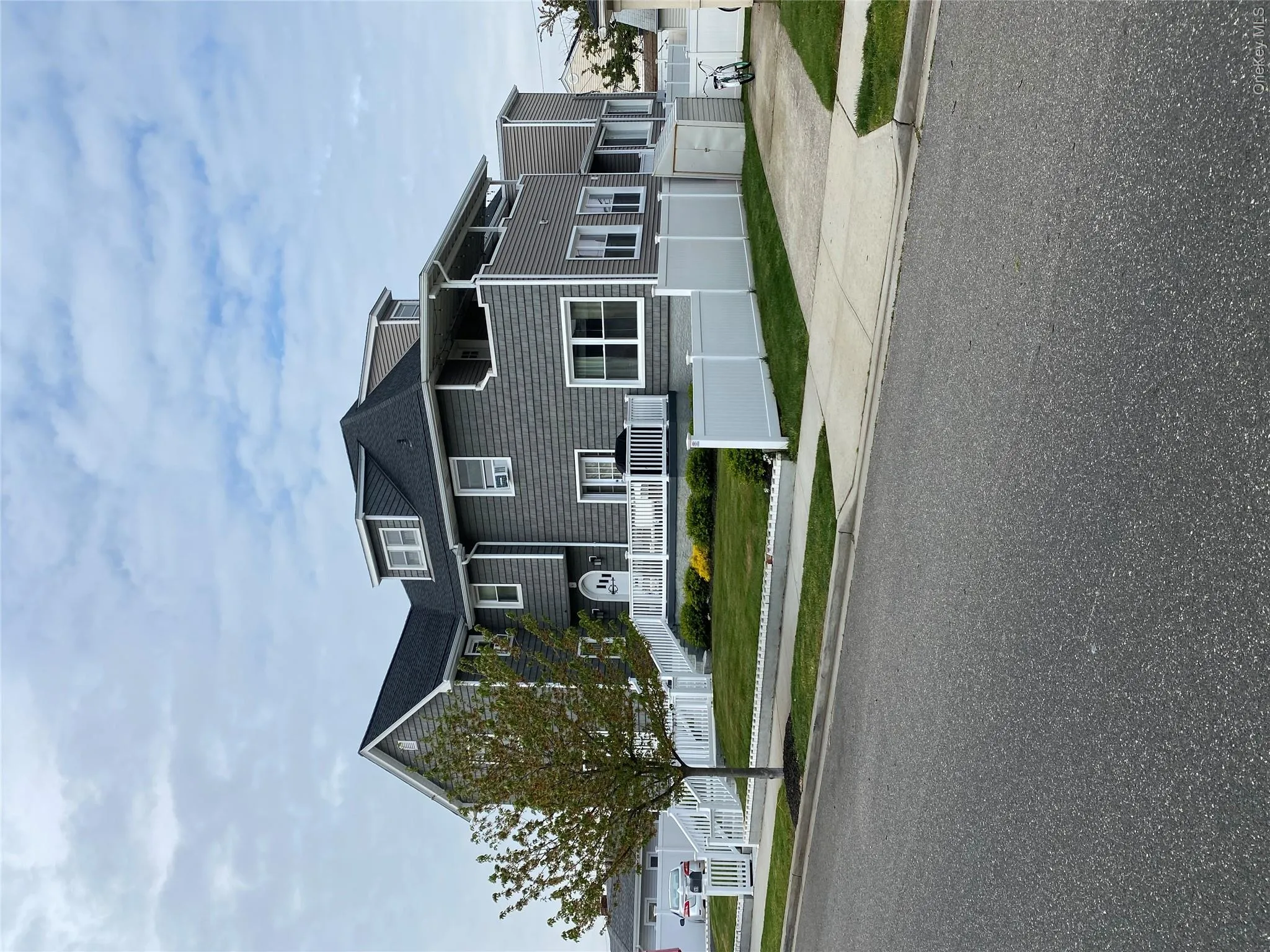 View of front of home featuring a fenced front yard, driveway, and roof with shingles View of front of home featuring a fenced front yard, driveway, and roof with shingles
