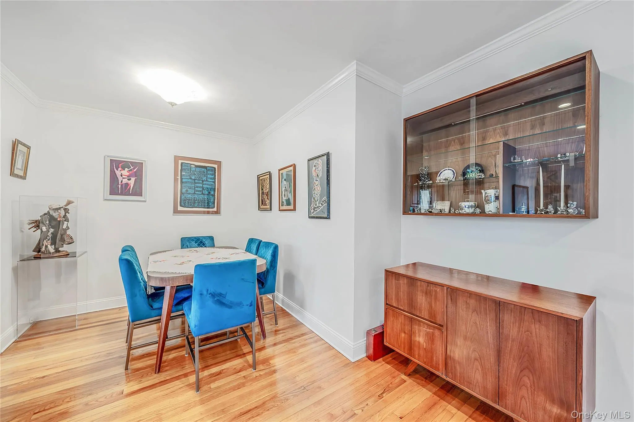 Wood-finish flooring, crown molding, and built-in wooden display cabinetry Wood-finish flooring, crown molding, and built-in wooden display cabinetry