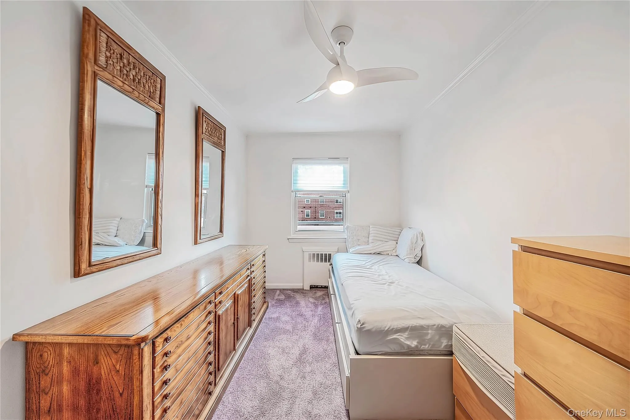 Room featuring neutral wall finishes, carpeting, and a modern three-blade ceiling fan with integrated lighting Room featuring neutral wall finishes, carpeting, and a modern three-blade ceiling fan with integrated lighting