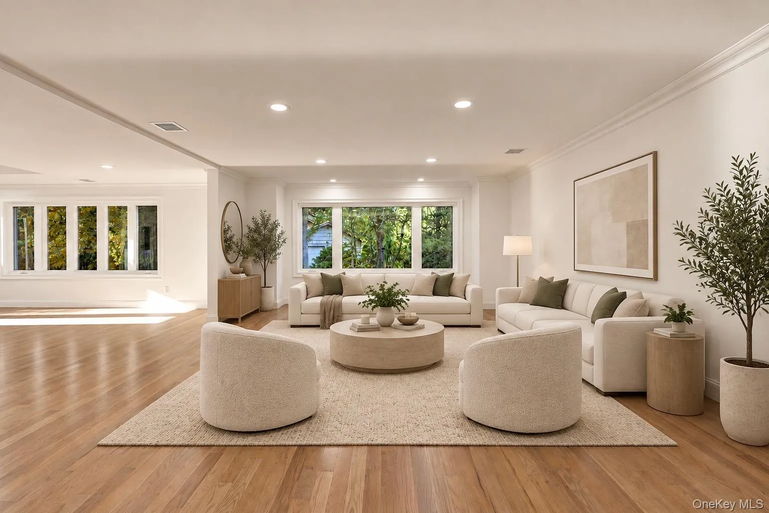 Open-concept interior featuring wood-finish flooring, recessed lighting, and expansive windows Open-concept interior featuring wood-finish flooring, recessed lighting, and expansive windows