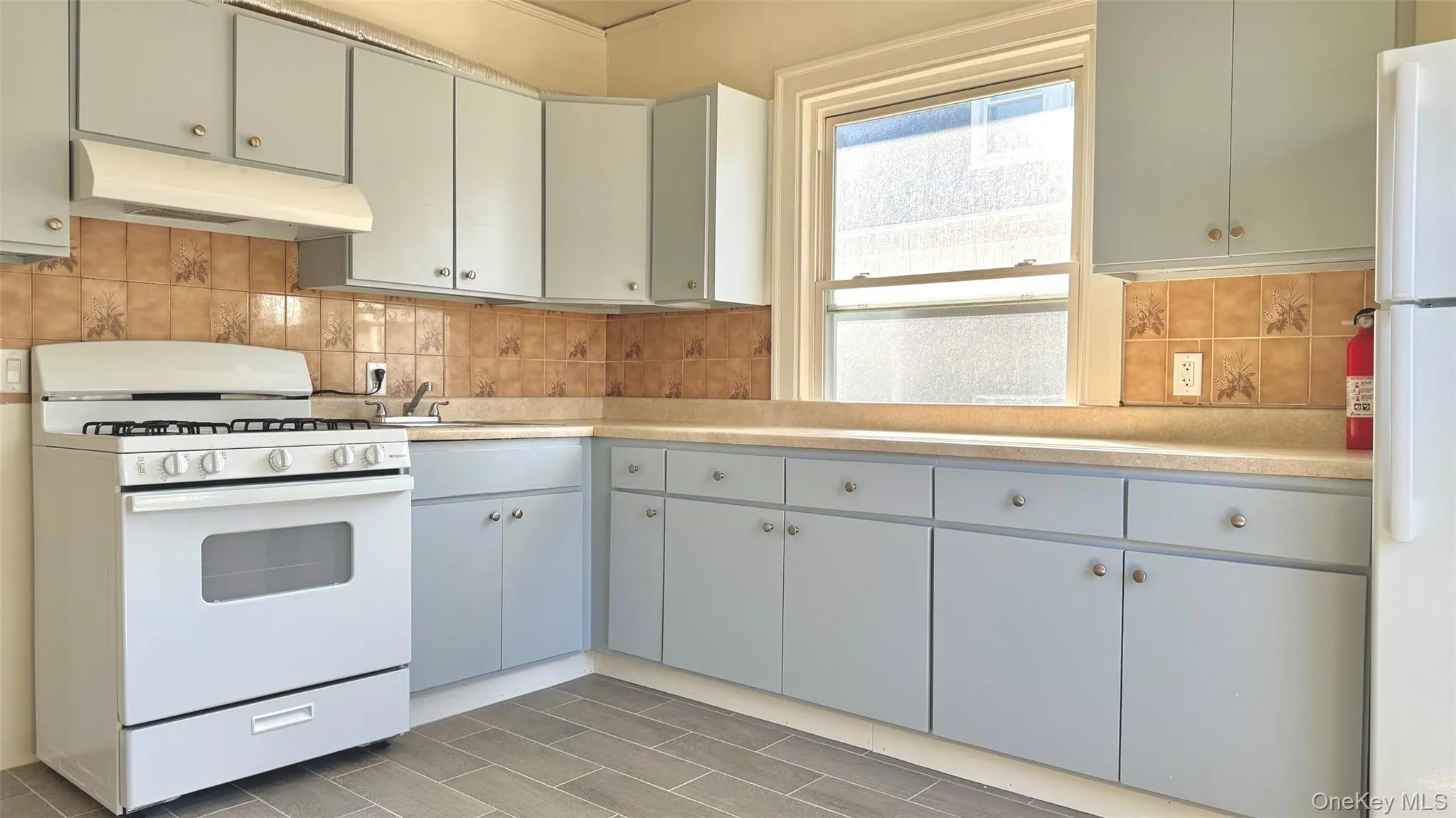 Eat-in kitchen with new flooring, refaced cabinets, new gas stove w/ exhaust fan, and new fridge. Nice flow of north facing afternoon light. Eat-in kitchen with new flooring, refaced cabinets, new gas stove w/ exhaust fan, and new fridge. Nice flow of north facing afternoon light.