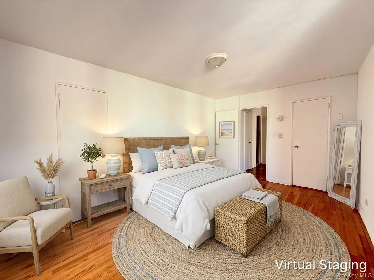 Room featuring wood-finish flooring and multiple interior doors Room featuring wood-finish flooring and multiple interior doors