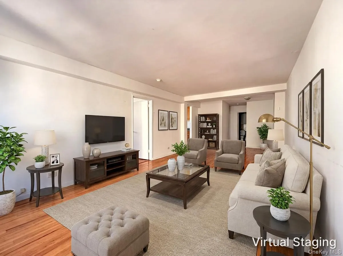 Open-concept living space featuring wood-finish flooring and neutral wall tones Open-concept living space featuring wood-finish flooring and neutral wall tones