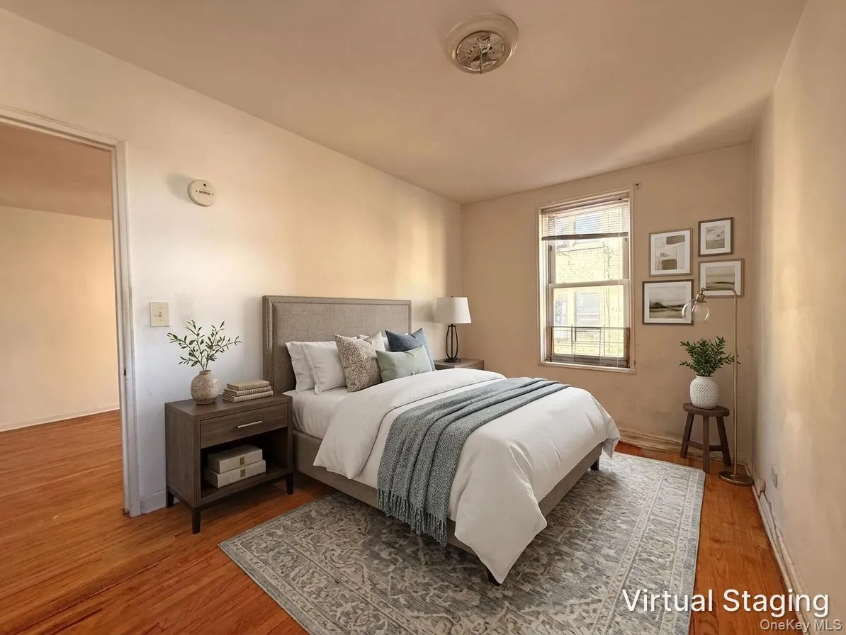 Wood-finish flooring, neutral wall tones, and a double-hung window with a classic trim profile Wood-finish flooring, neutral wall tones, and a double-hung window with a classic trim profile