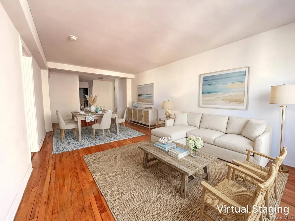 Open-concept interior featuring wood-finish flooring and neutral wall tones Open-concept interior featuring wood-finish flooring and neutral wall tones