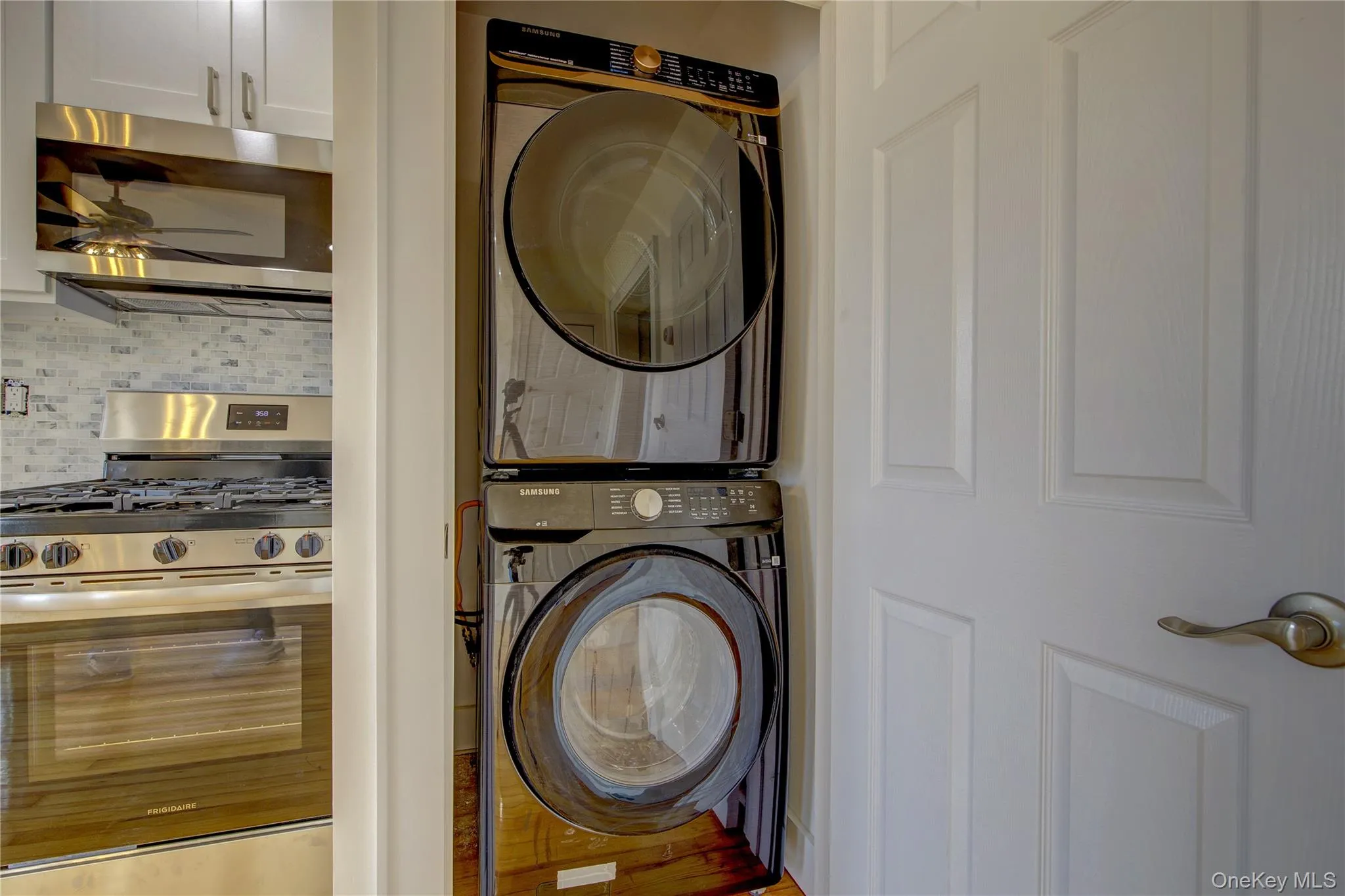 Laundry area featuring laundry area, stacked washer and clothes dryer, and ceiling fan Laundry area featuring laundry area, stacked washer and clothes dryer, and ceiling fan