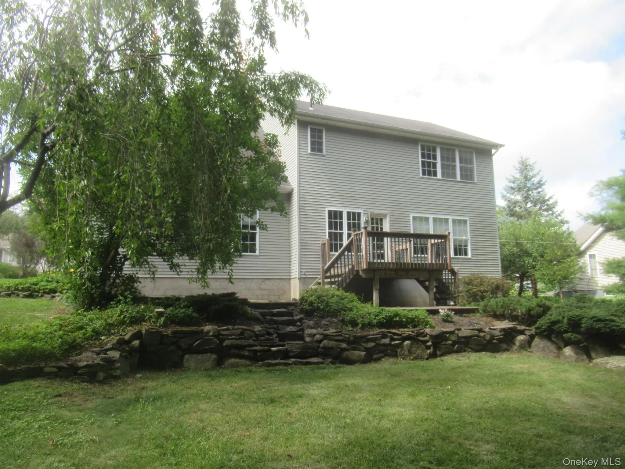Rear exterior, deck and stone wall Rear exterior, deck and stone wall
