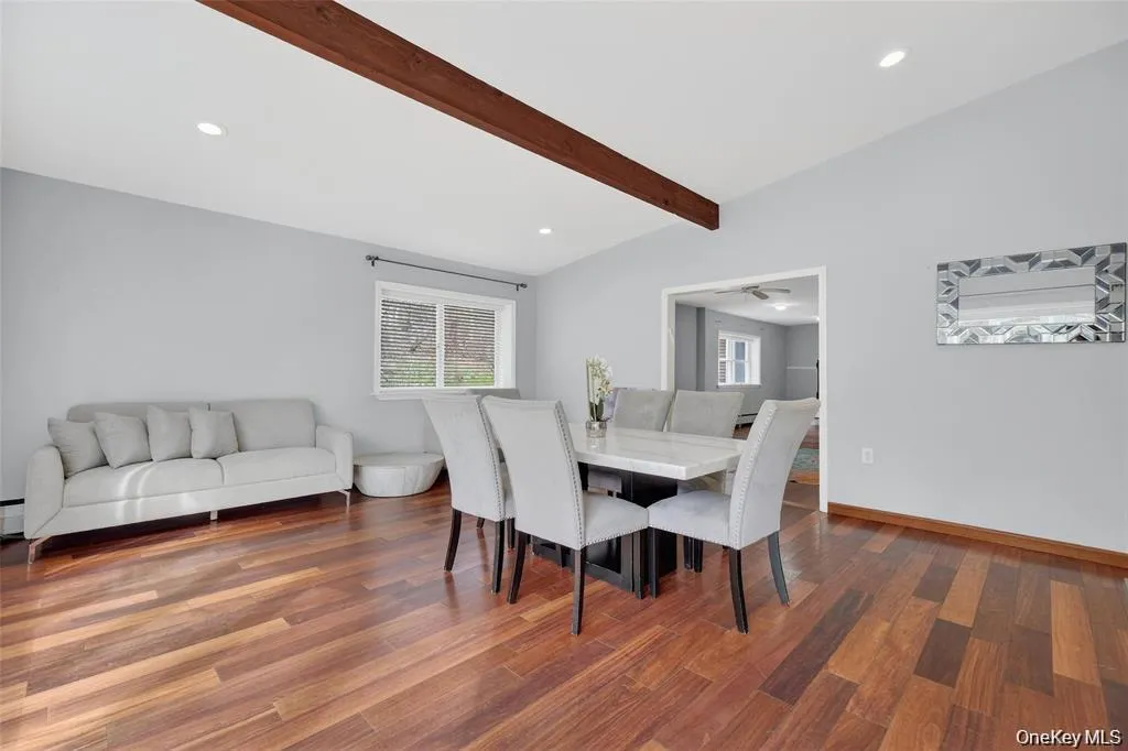 Dining area featuring recessed lighting, dark wood-style flooring, and lofted ceiling with beams Dining area featuring recessed lighting, dark wood-style flooring, and lofted ceiling with beams
