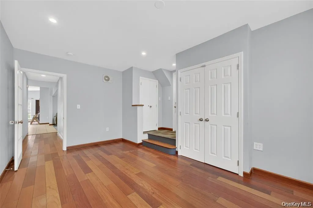 Unfurnished room with lightwood-style flooring, a closet, and recessed lighting Unfurnished room with lightwood-style flooring, a closet, and recessed lighting