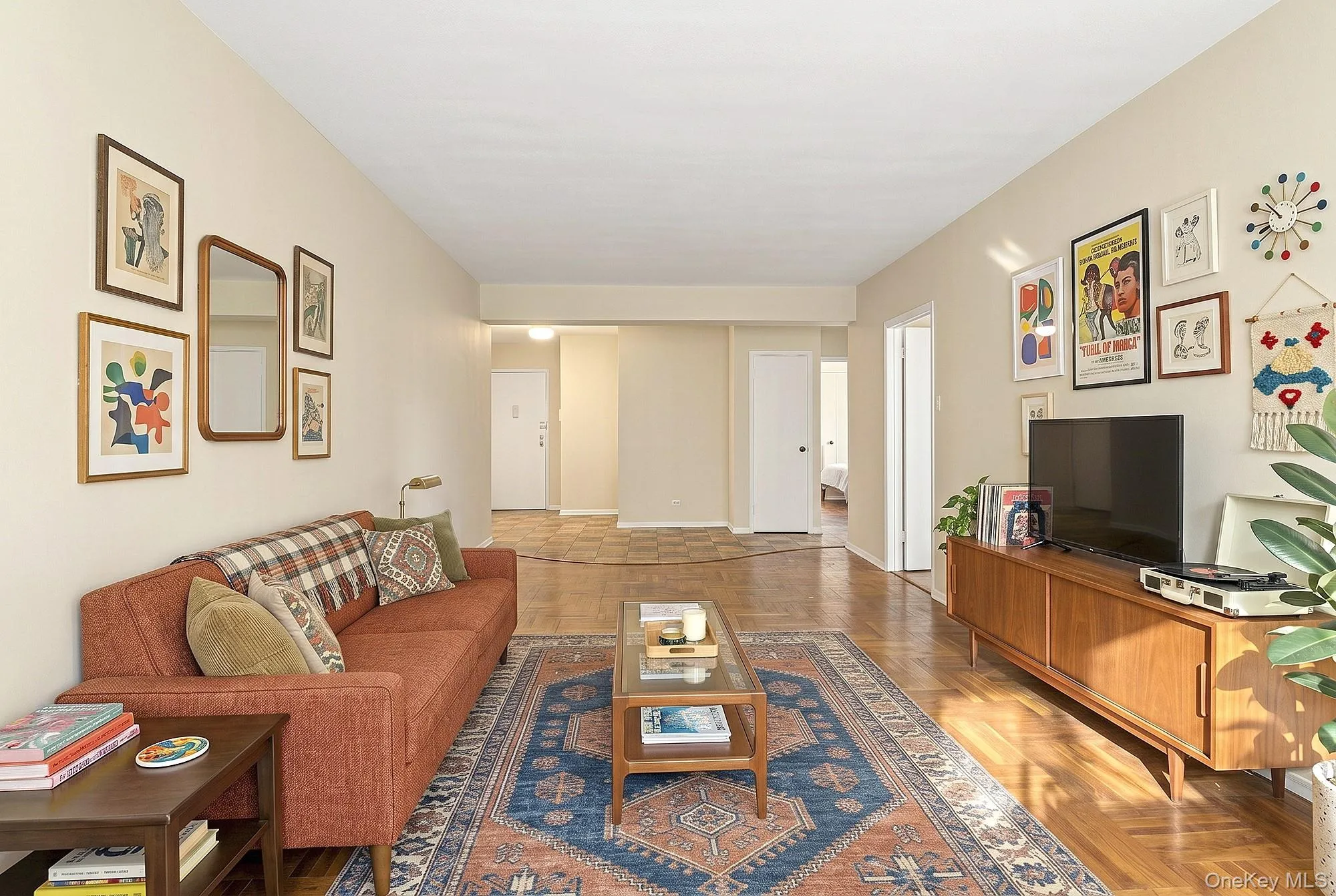 Large living room with oversized windows and hardwood floors that need TLC Large living room with oversized windows and hardwood floors that need TLC