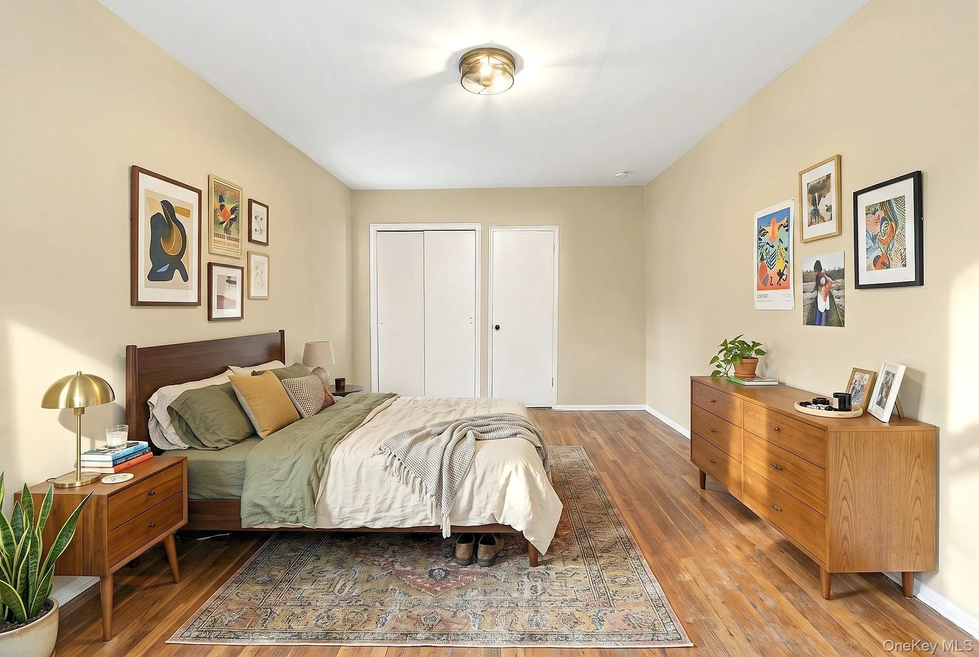 Primary bedroom with two exposures, and hardwood floors that need TLC Primary bedroom with two exposures, and hardwood floors that need TLC