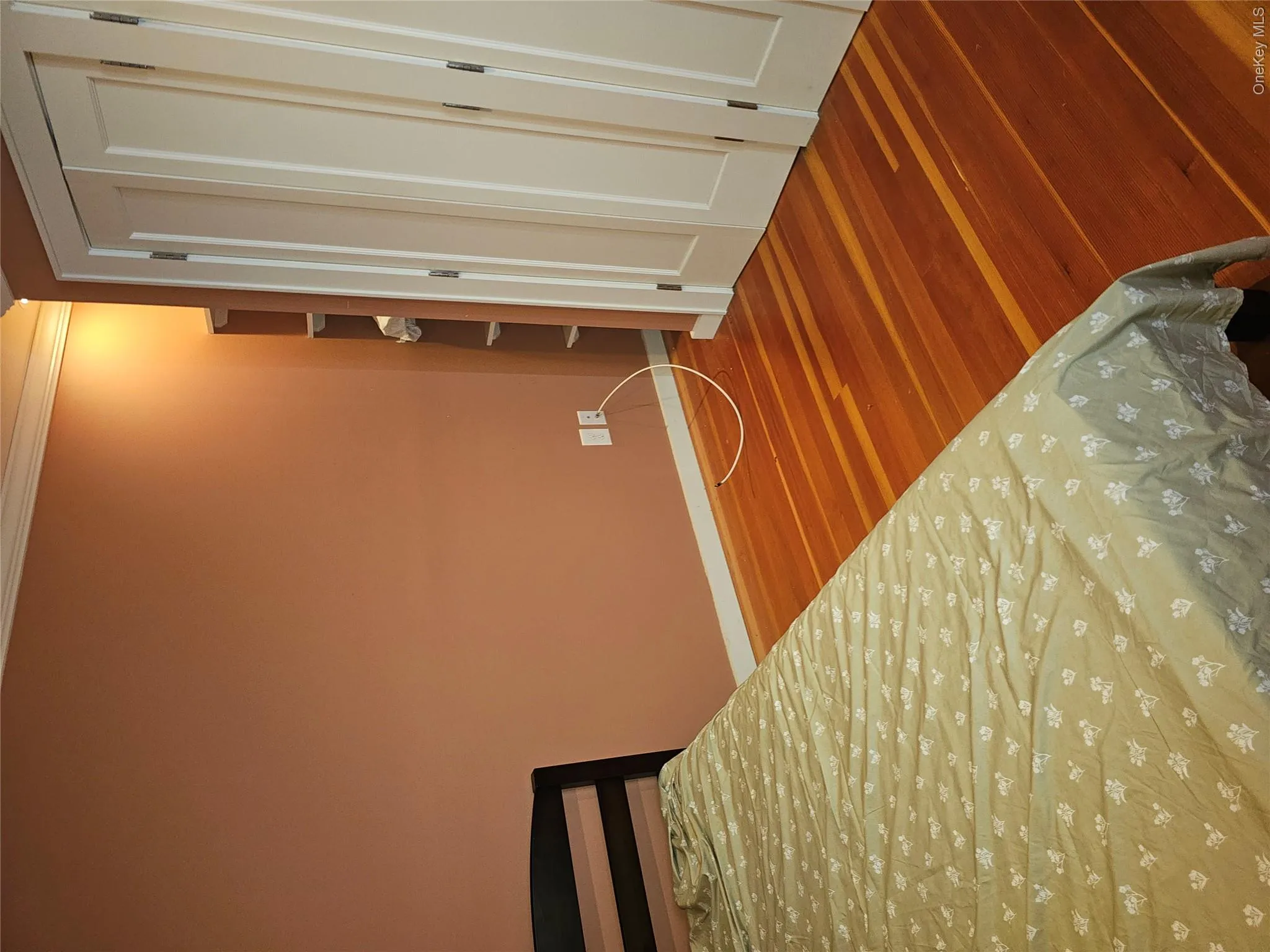 Wood-finish flooring, white paneled bi-fold closet doors, and built-in shelving Wood-finish flooring, white paneled bi-fold closet doors, and built-in shelving