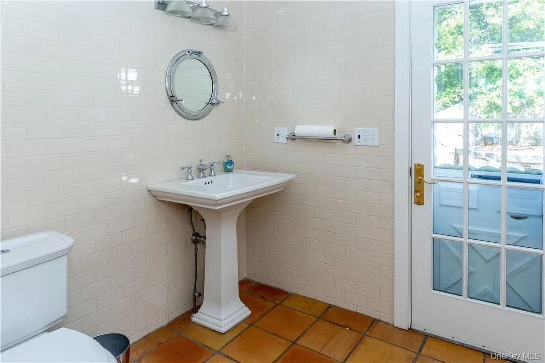 1 of 2 powder rooms. This one has access to the back patio and pool area. 1 of 2 powder rooms. This one has access to the back patio and pool area.