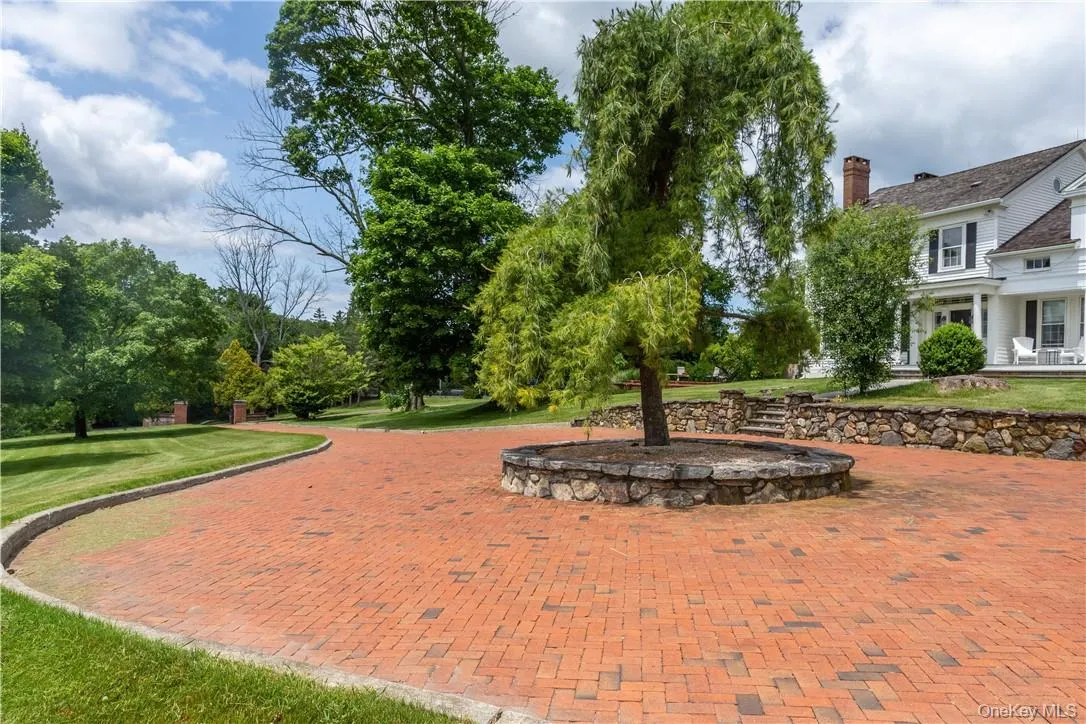Stone pillars at entry lead to the brick circular driveway at front of the home. Stone pillars at entry lead to the brick circular driveway at front of the home.