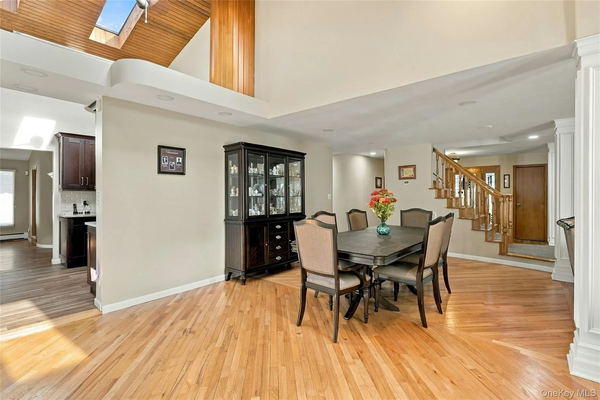 Vaulted ceilings with wood-plank detailing, recessed lighting, skylight, wood-finish flooring, and a staircase with decorative wood railings Vaulted ceilings with wood-plank detailing, recessed lighting, skylight, wood-finish flooring, and a staircase with decorative wood railings