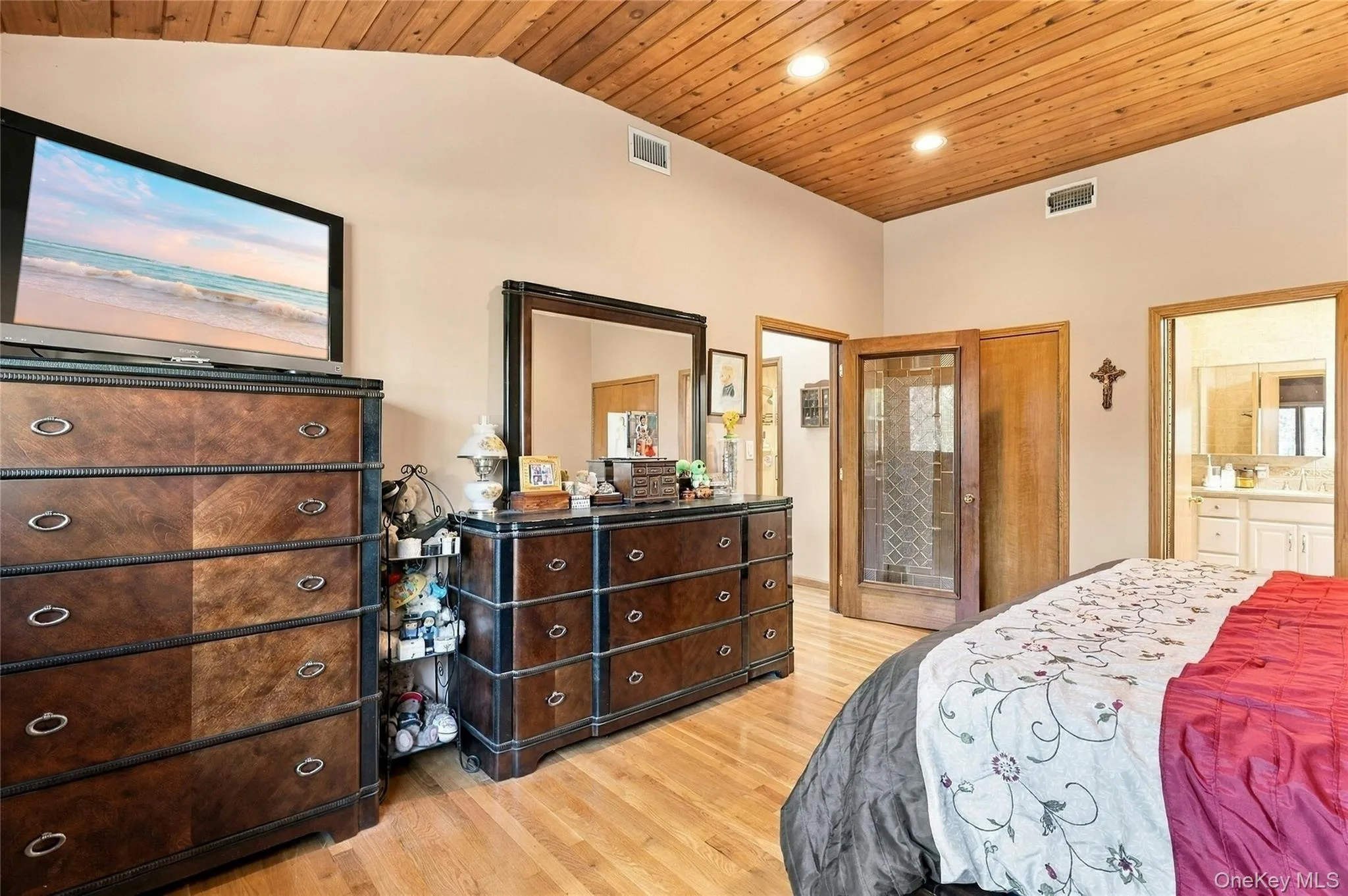 Vaulted ceiling with wood-plank paneling, recessed lighting, and wood-finish flooring Vaulted ceiling with wood-plank paneling, recessed lighting, and wood-finish flooring