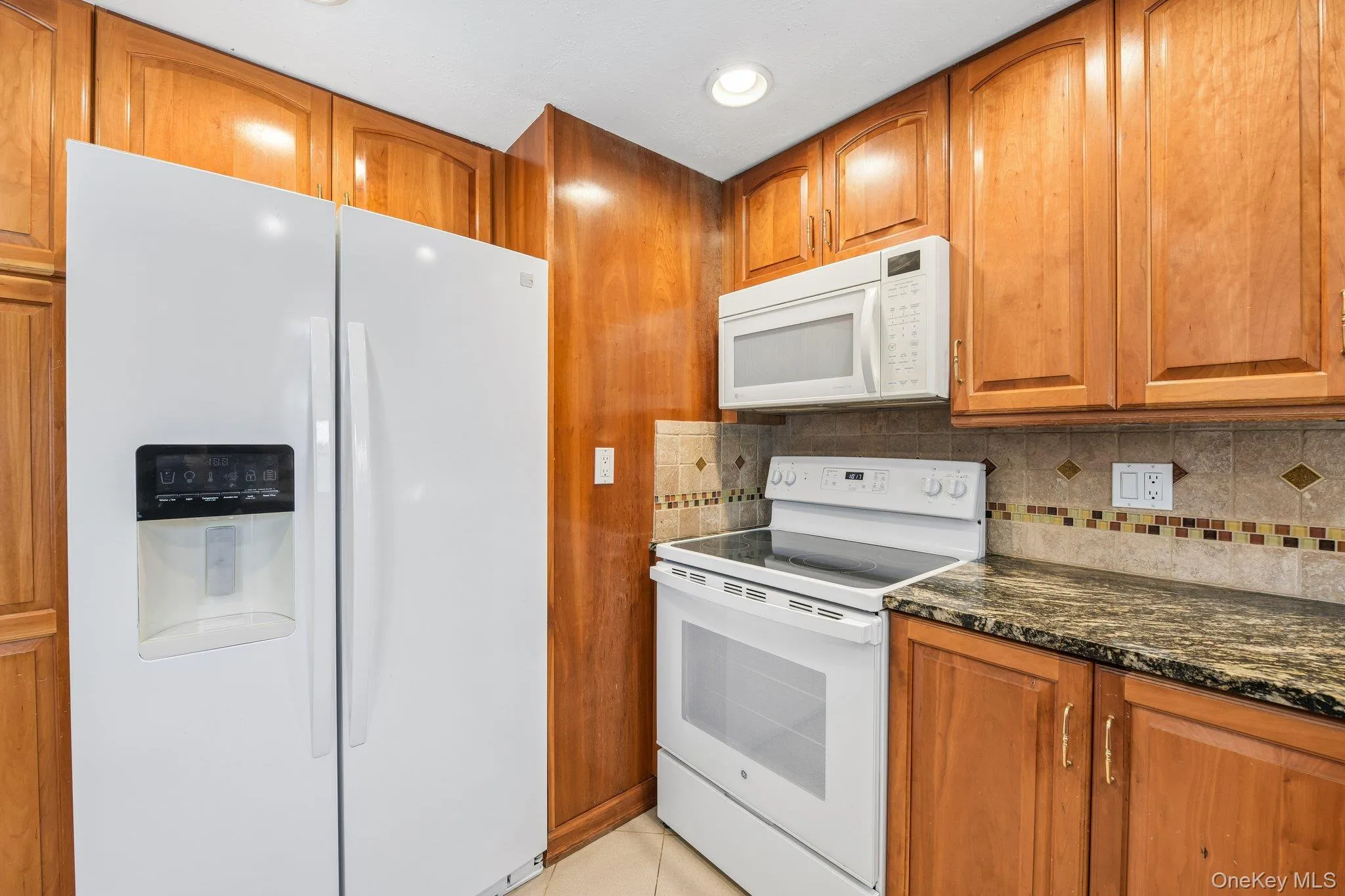 Kitchen view of Refrigerator & Electric Range Kitchen view of Refrigerator & Electric Range