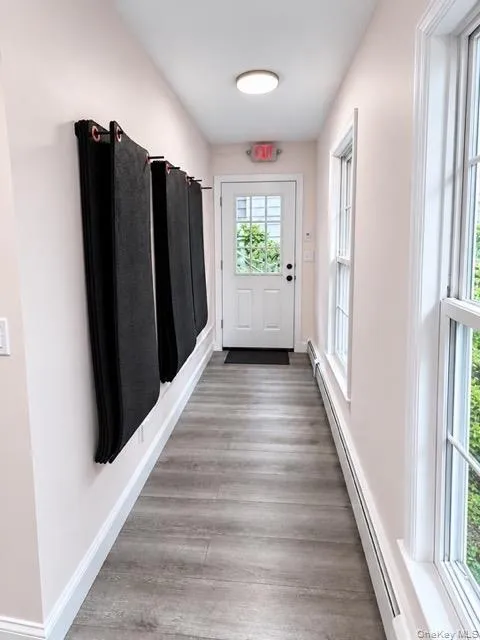 Hallway to rear entrance and parking lot Hallway to rear entrance and parking lot