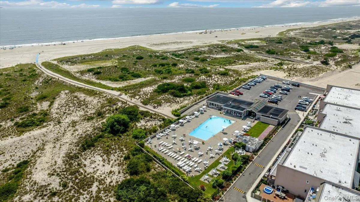 Aerial view featuring a water view and a view of the beach Aerial view featuring a water view and a view of the beach