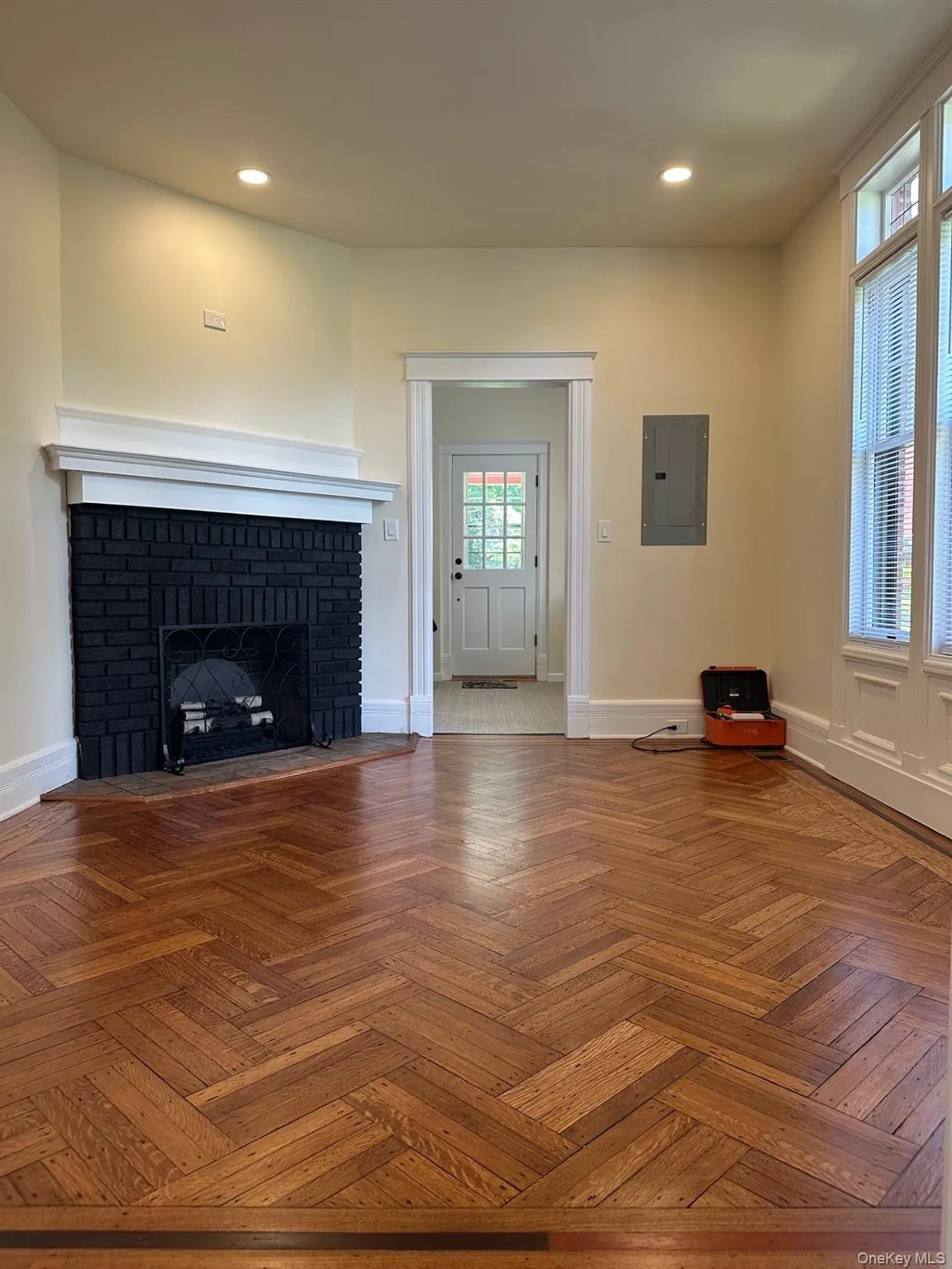 panel, a fireplace, and recessed lighting panel, a fireplace, and recessed lighting