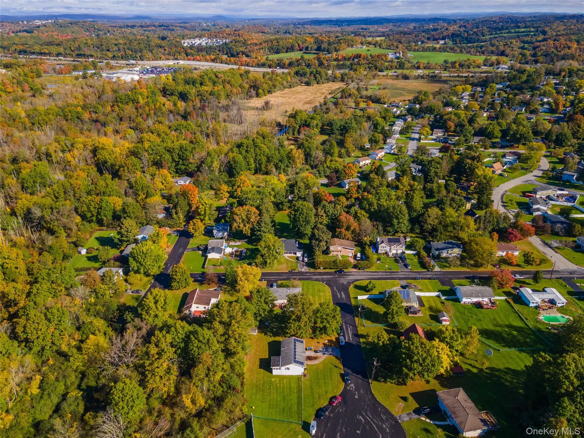 Aerial perspective of a residential neighborhood featuring expansive wooded areas, mature tree canopy, and established paved roadways Aerial perspective of a residential neighborhood featuring expansive wooded areas, mature tree canopy, and established paved roadways