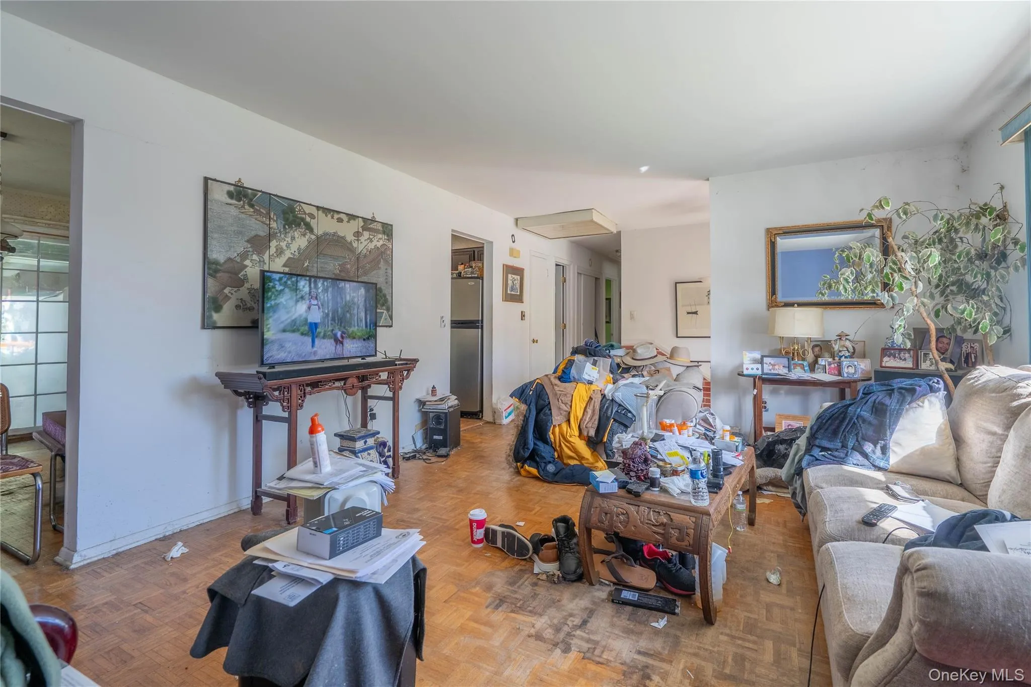 Interior space featuring parquet wood-finish flooring and neutral wall color Interior space featuring parquet wood-finish flooring and neutral wall color